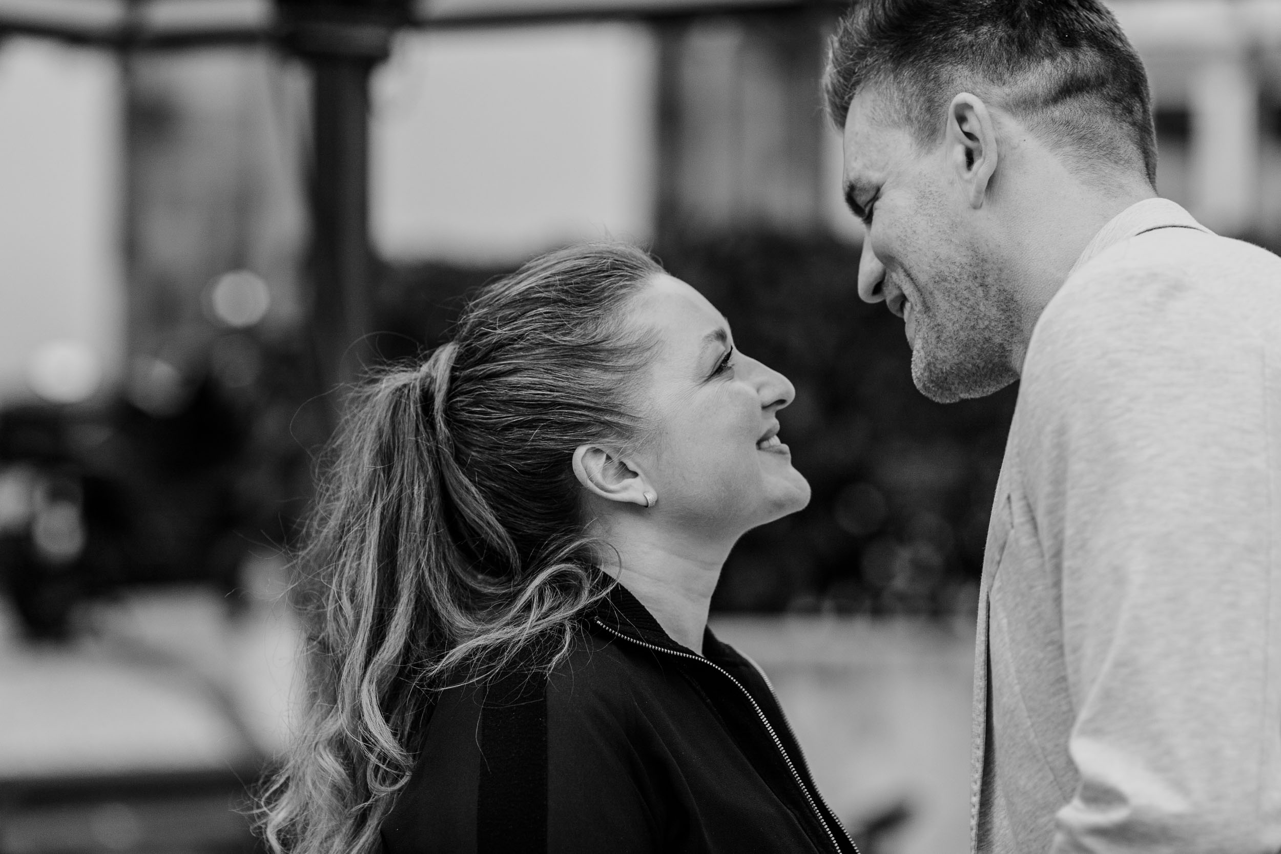 Black and white close portrait of couple, faces almost touching, eyes closed, cafe setting, Funchal, Madeira