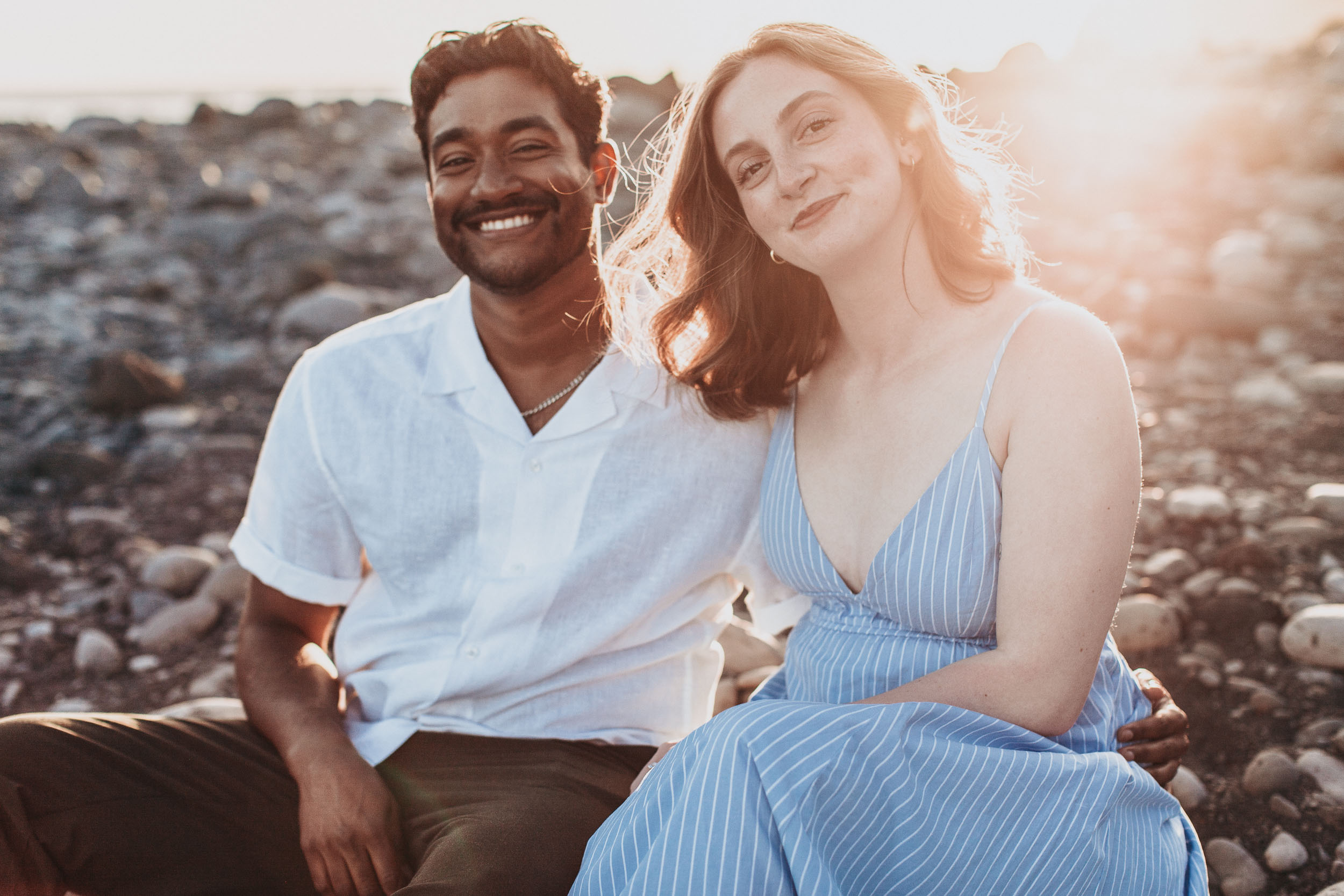 Engaged couple on rocky shore, Praia Formosa, Madeira