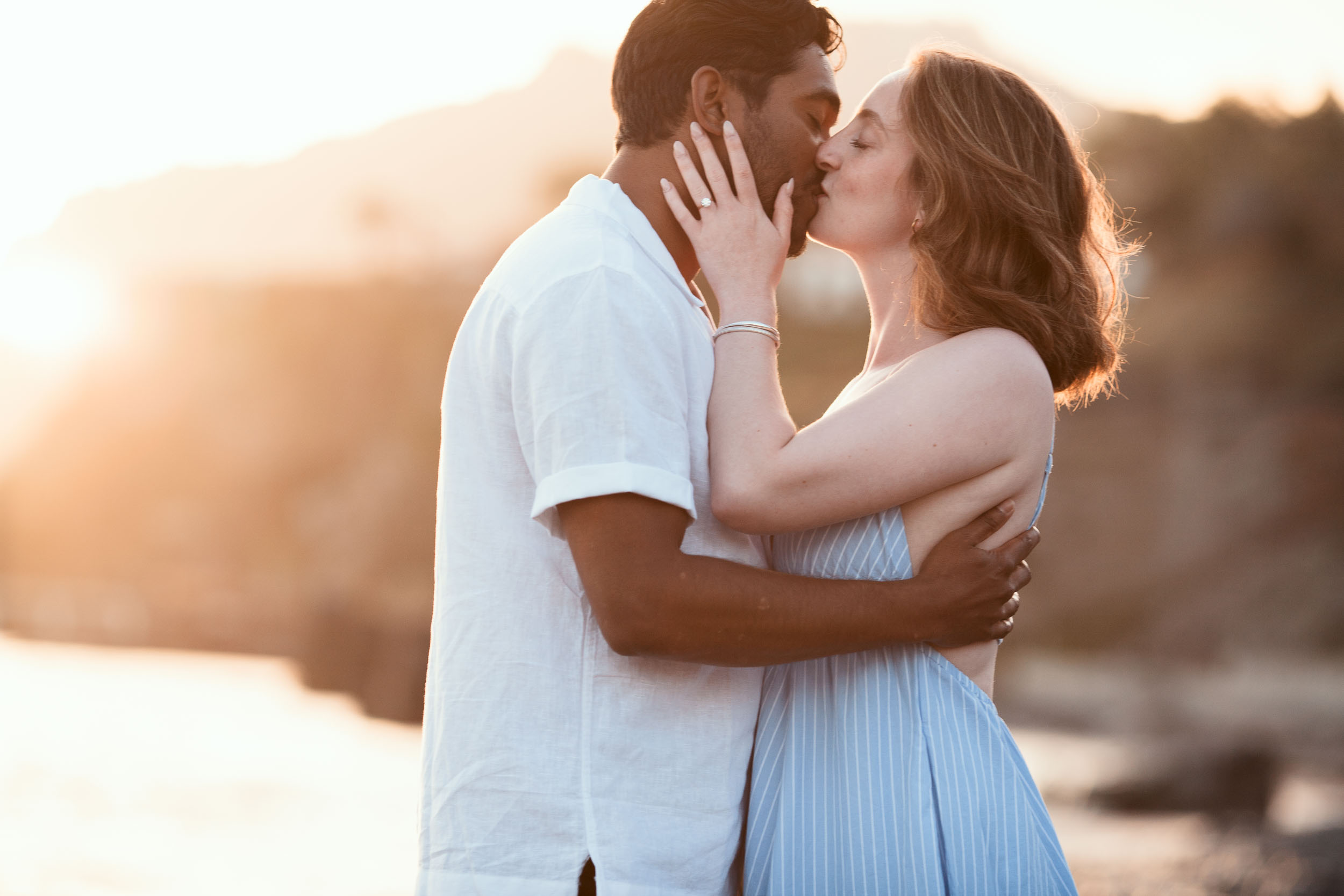 Engaged couple on rocky shore, Praia Formosa, Madeira