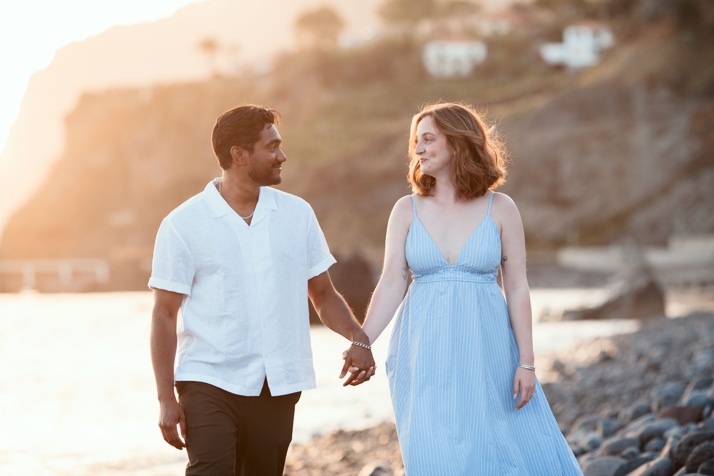 Couple on black volcanic rocks at Praia Formosa, Madeira