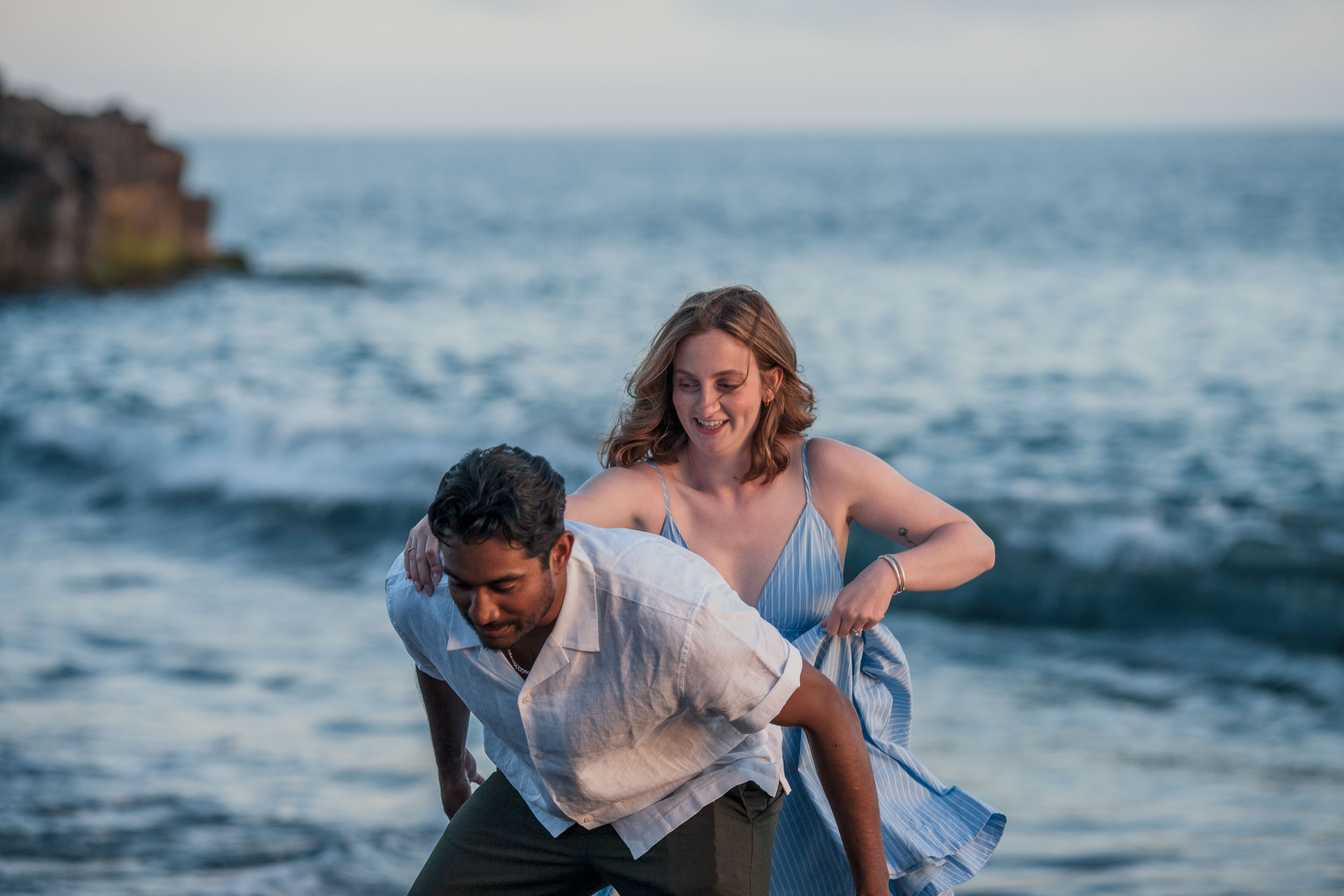 Couple kissing at Praia Formosa, Funchal, Madeira