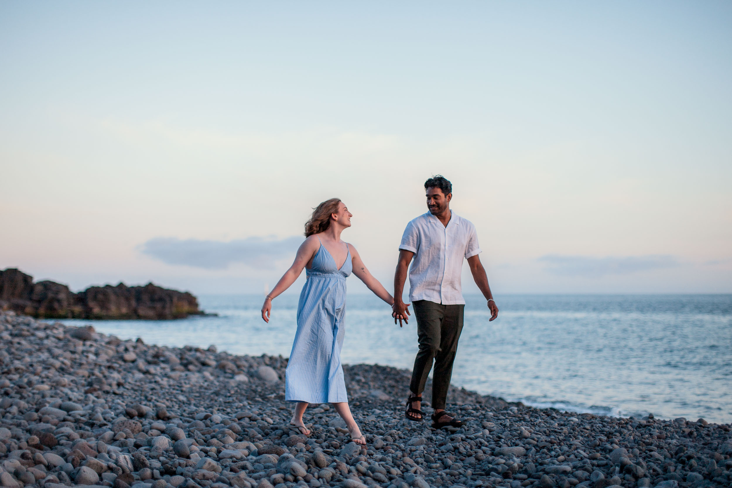Couple holding hands at Atlantic shore, Praia Formosa, Madeira