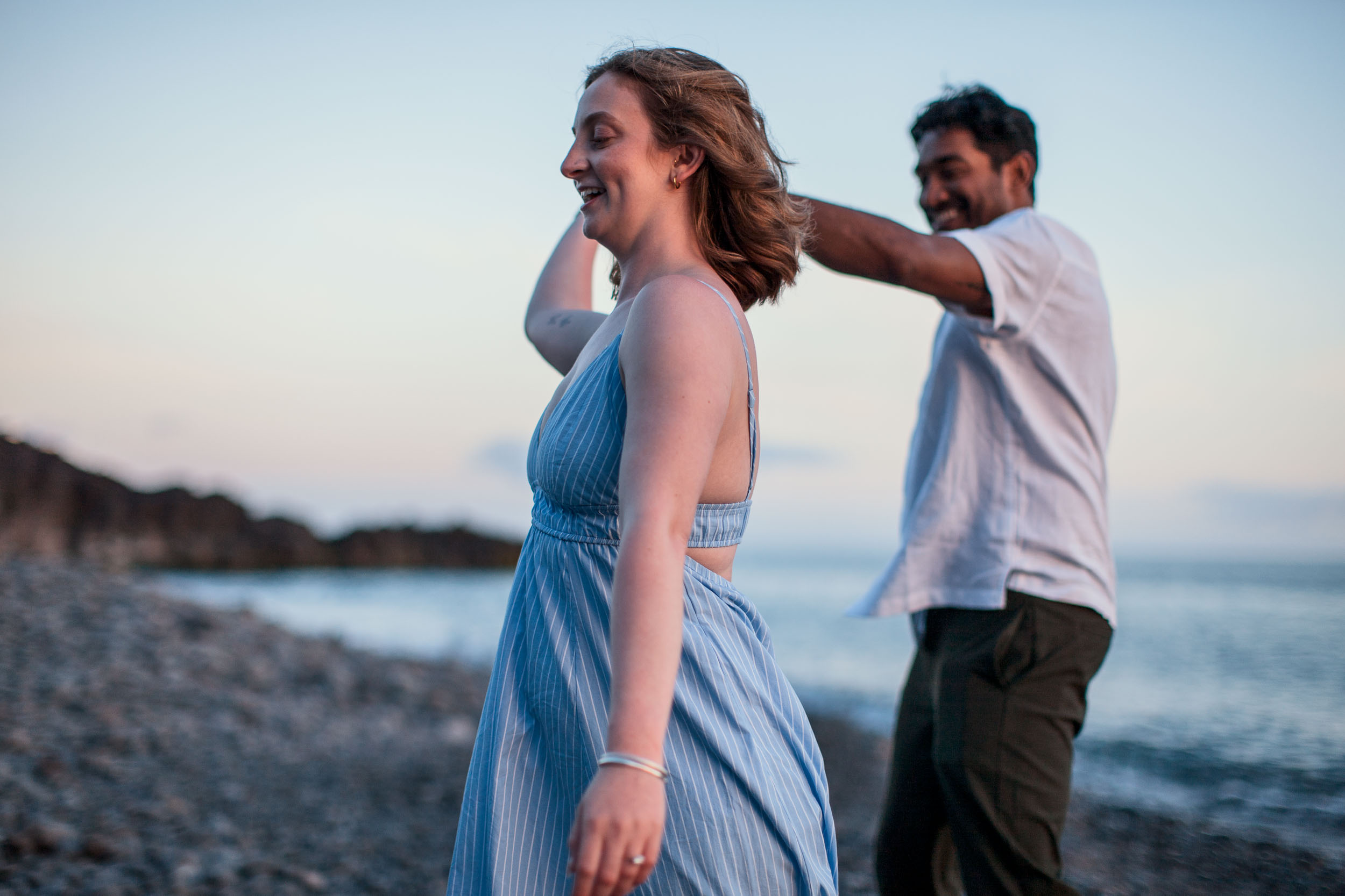 Couple on Praia Formosa beach at dusk, Funchal, Madeira