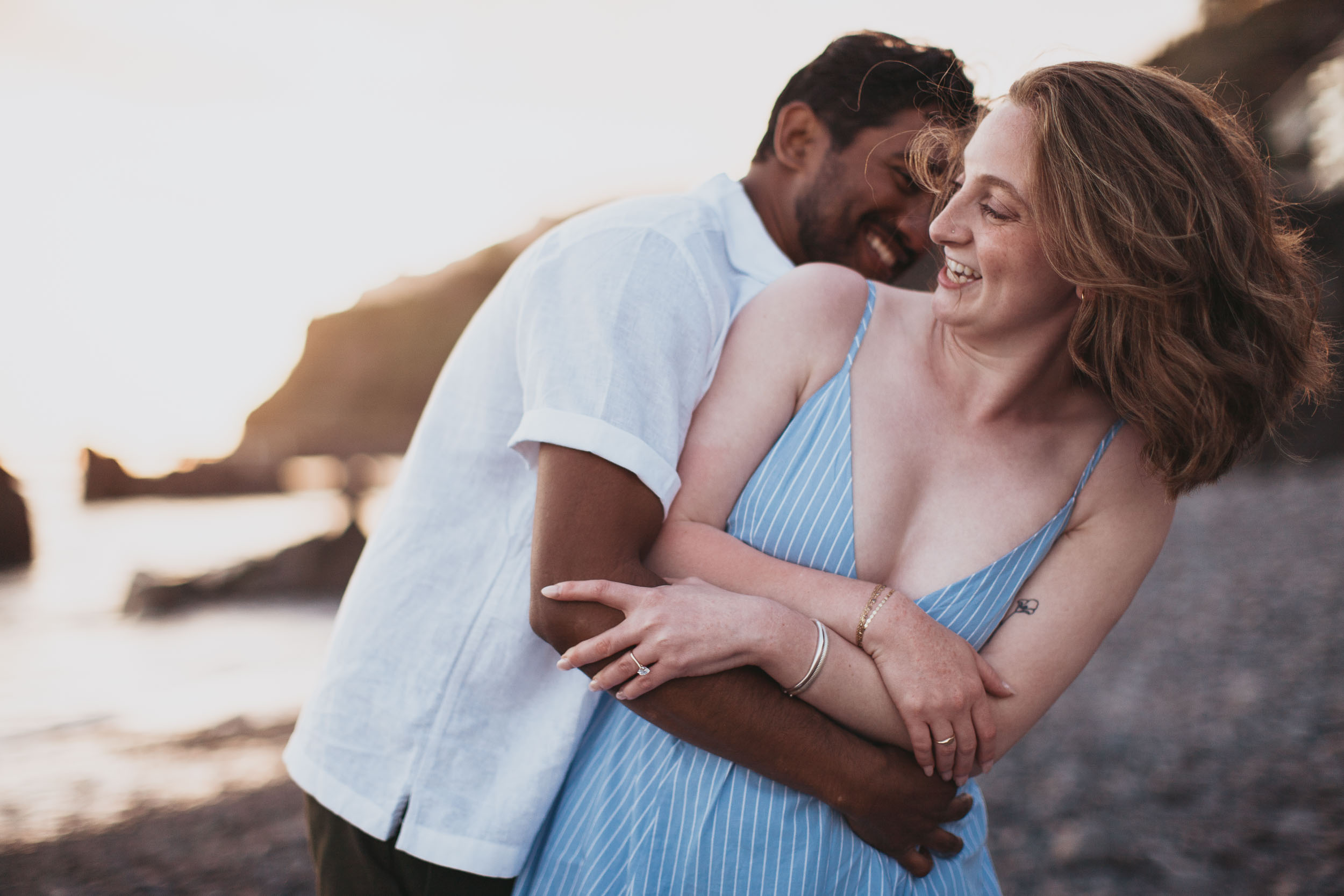 Couple at Praia Formosa beach at sunset, Funchal, Madeira