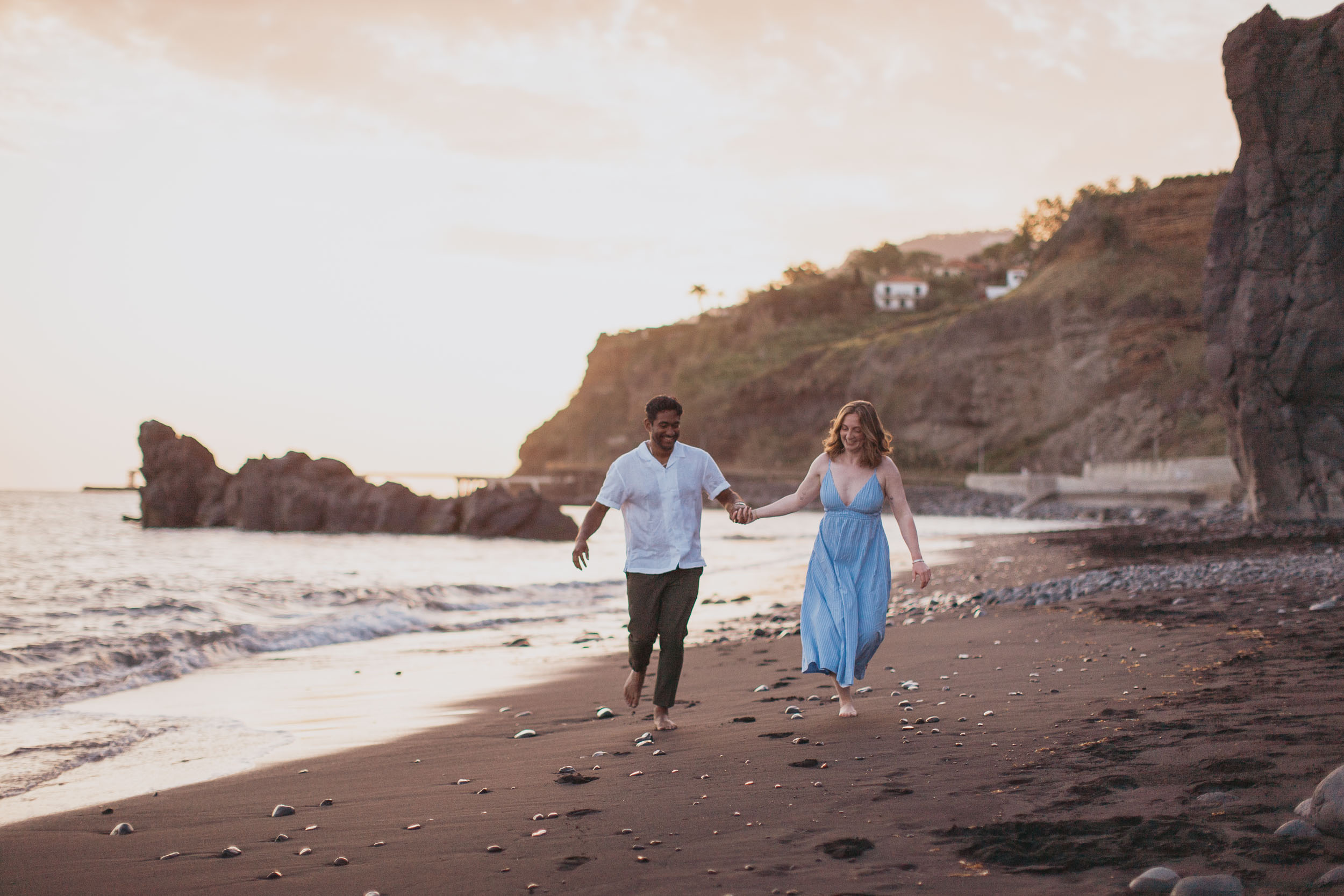 Couple walking at golden hour on Praia Formosa, Funchal, Madeira