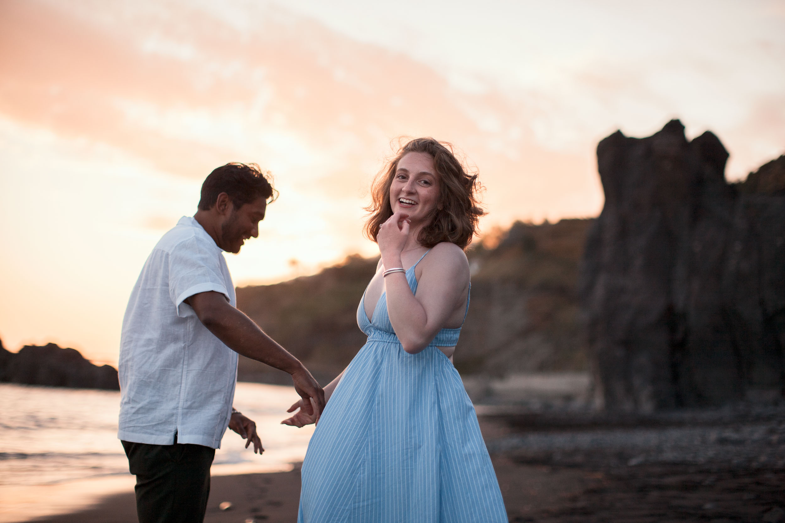 Engaged couple on rocky shore, Praia Formosa, Madeira