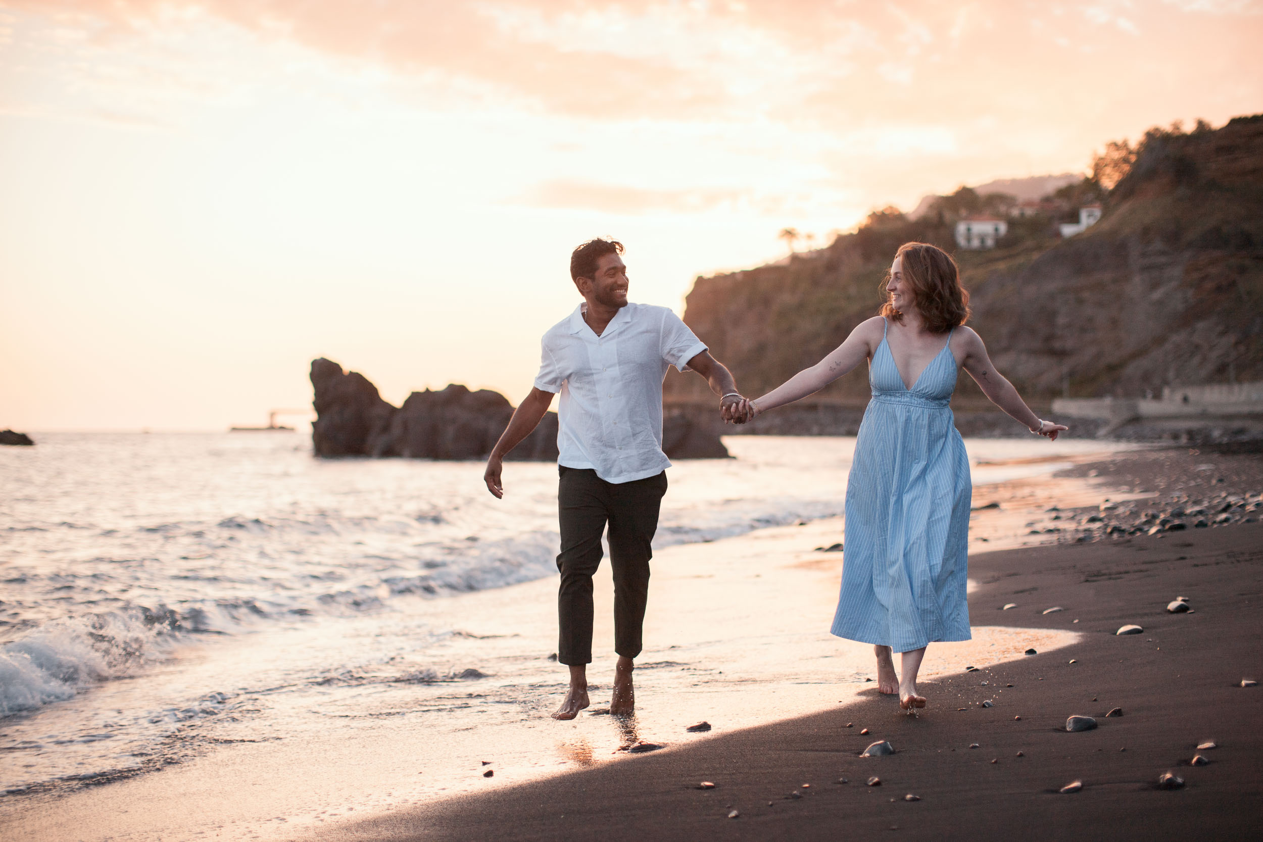 Couple on Praia Formosa beach at dusk, Funchal, Madeira