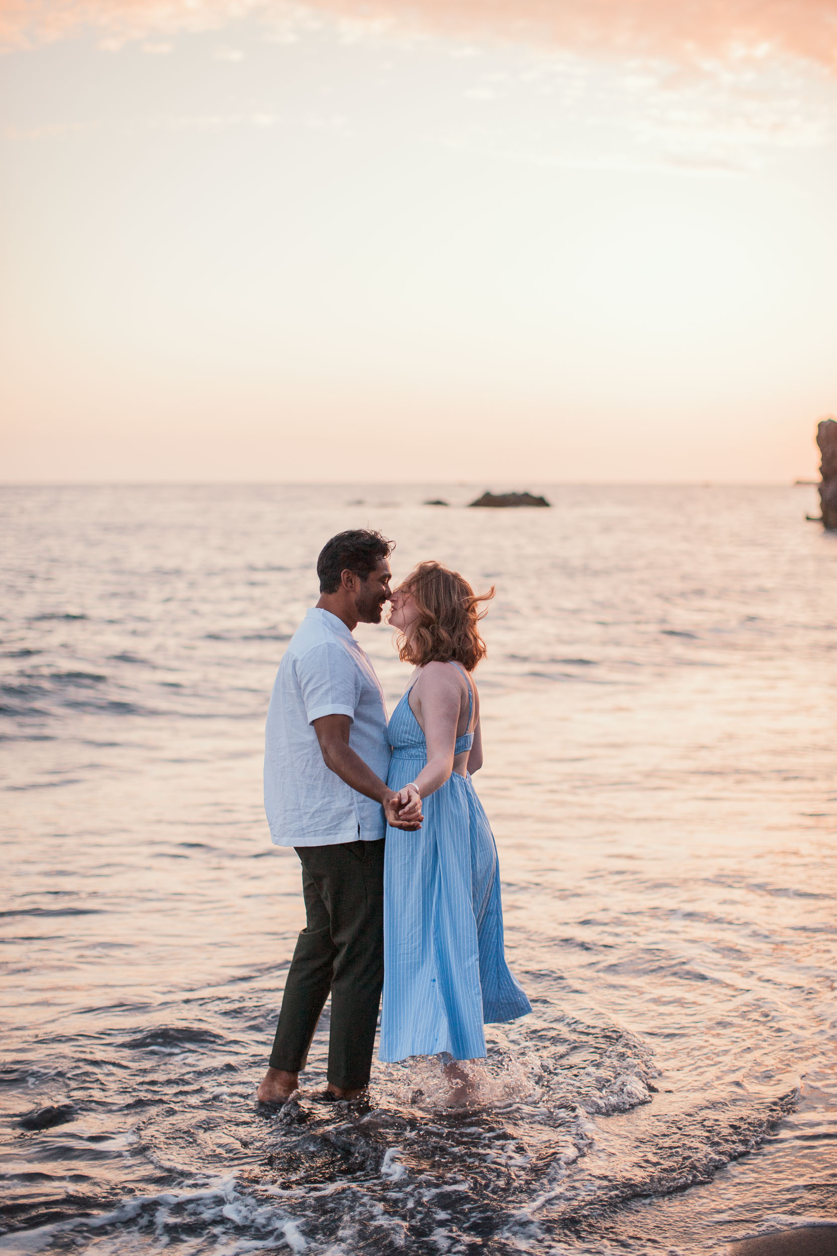 Couple silhouette at dusk, Praia Formosa beach, Madeira