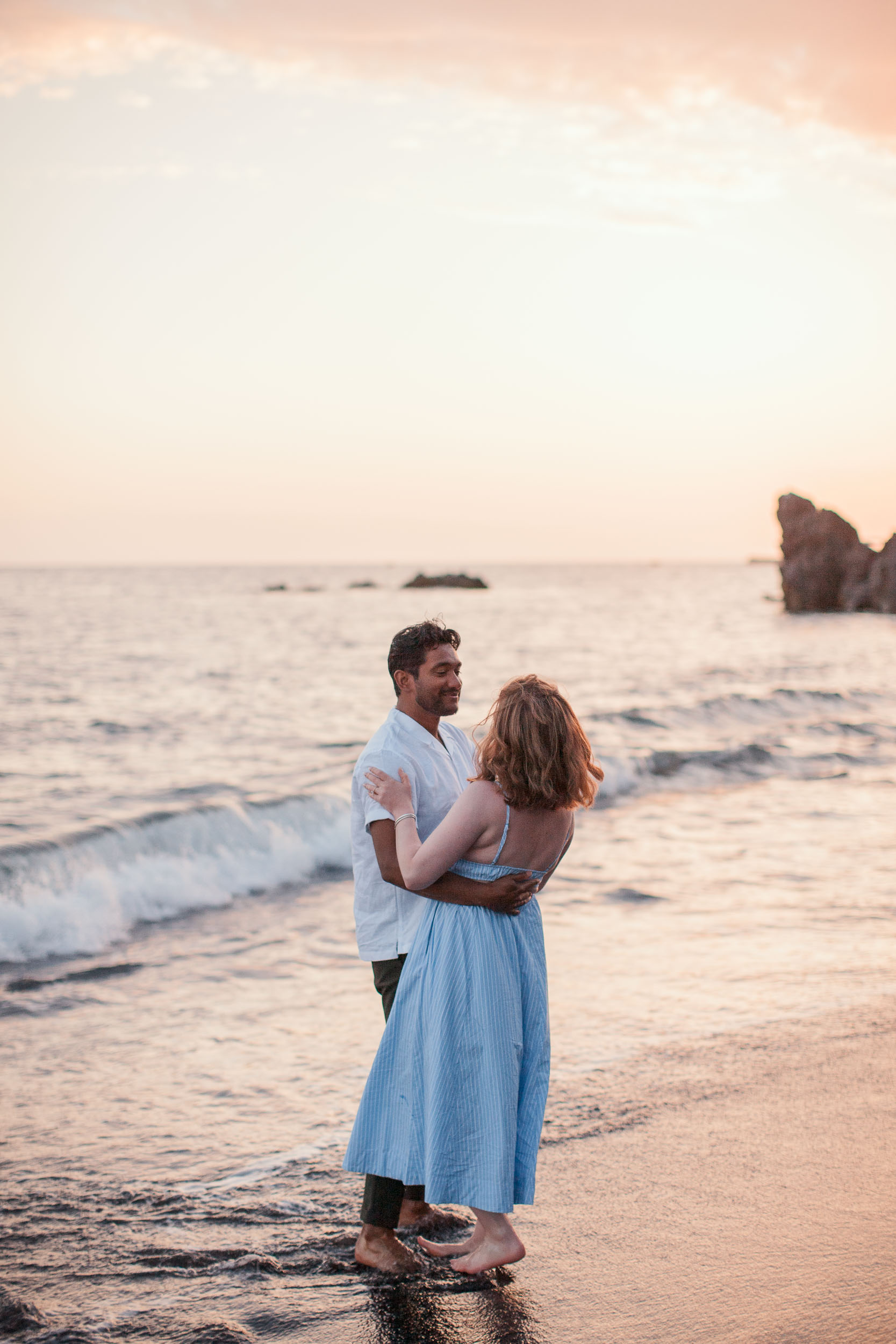 Couple at Praia Formosa beach at sunset, Funchal, Madeira