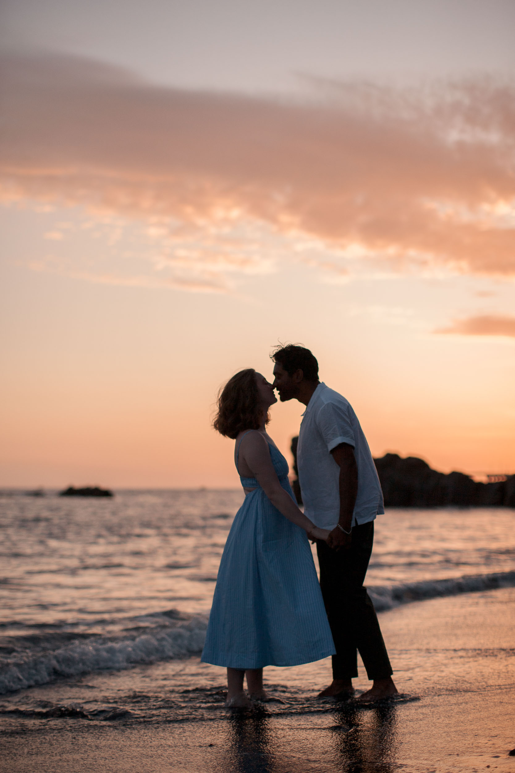 Couple embracing at Praia Formosa, Madeira