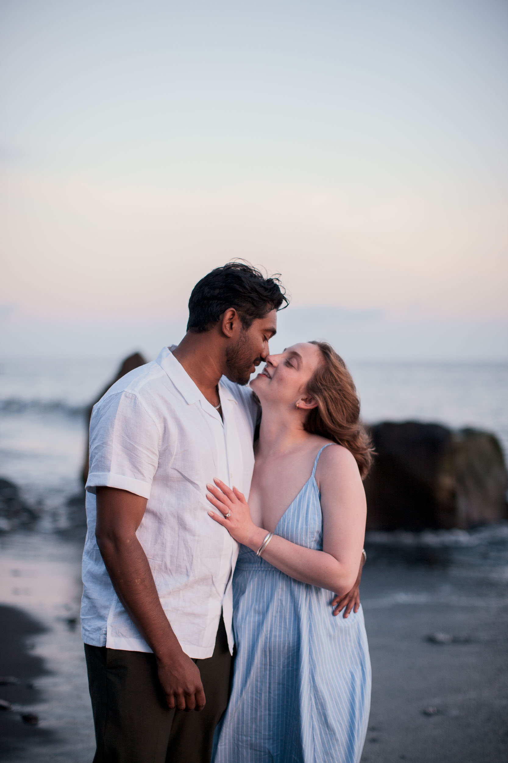 Couple holding hands at Atlantic shore, Praia Formosa, Madeira