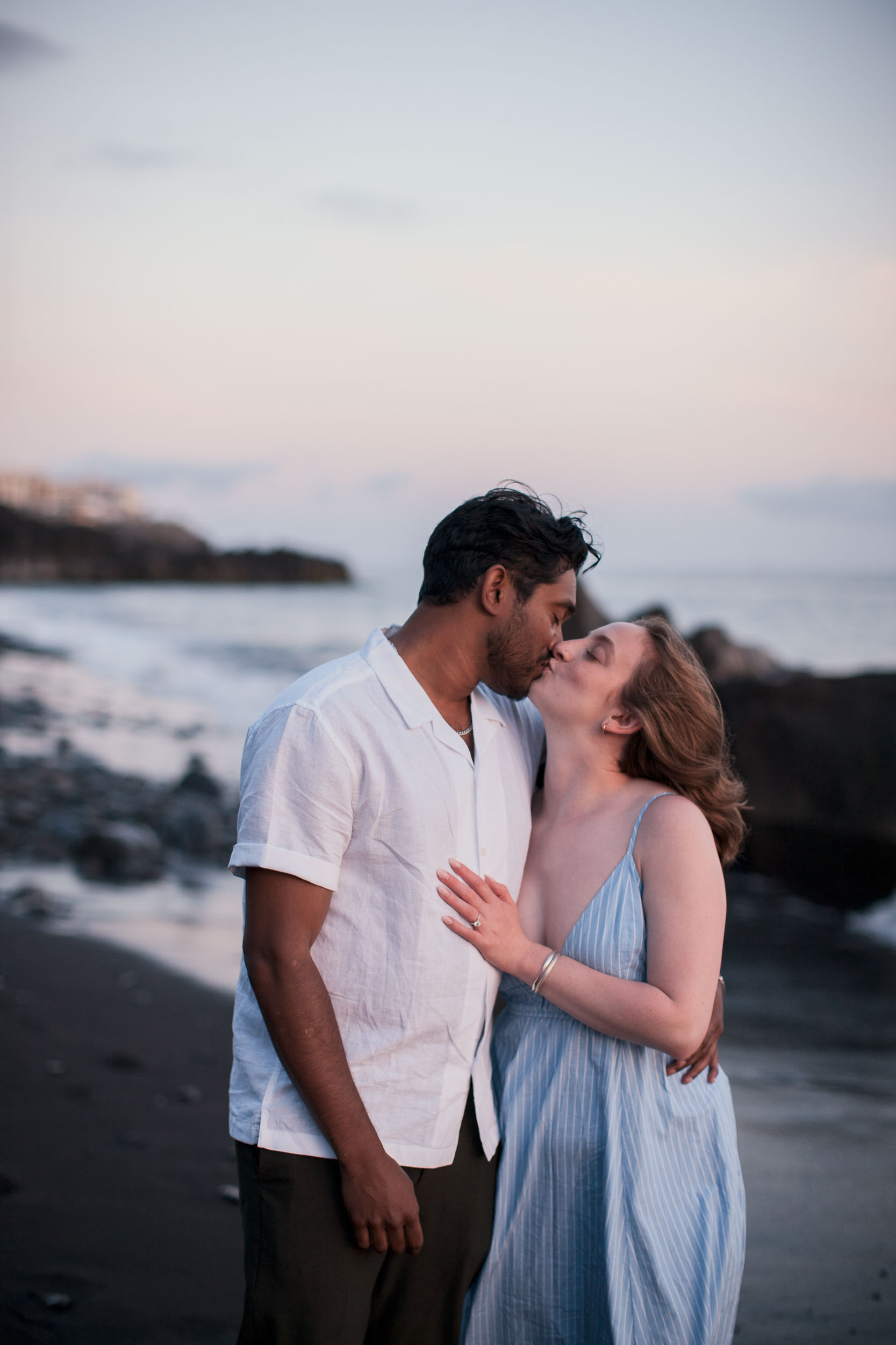 Couple on Praia Formosa beach at dusk, Funchal, Madeira
