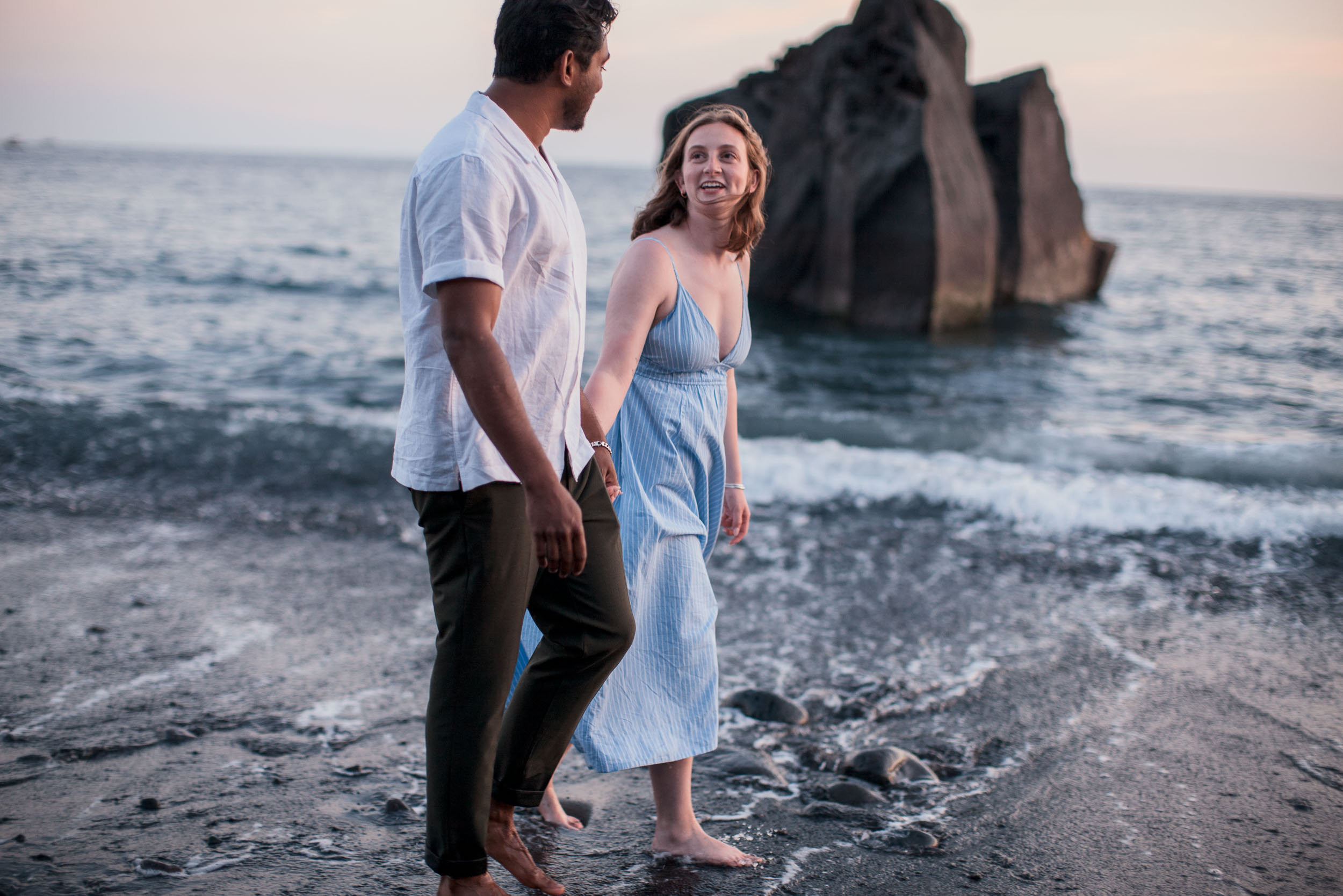 Couple at Praia Formosa beach at sunset, Funchal, Madeira