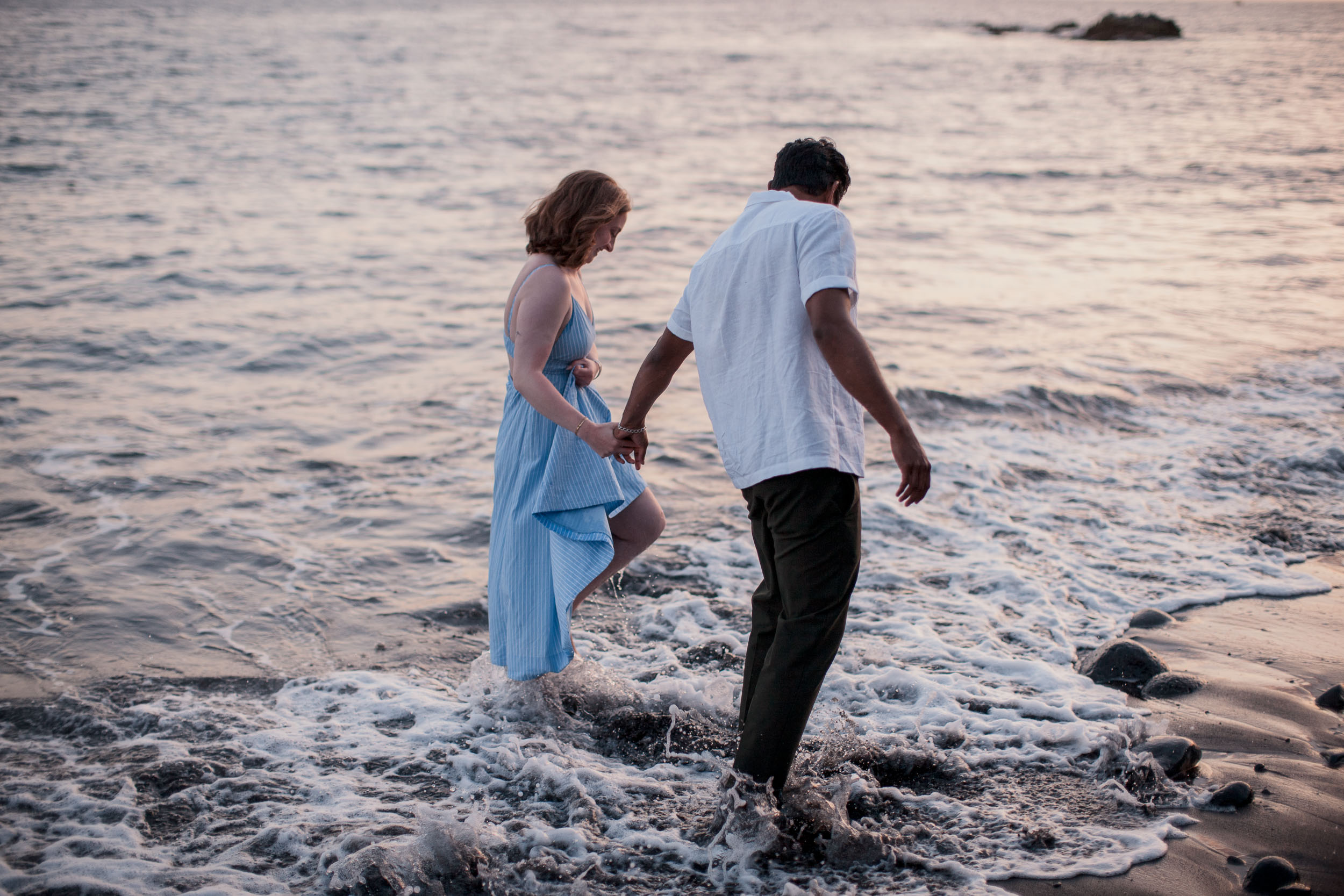 Couple embracing at Praia Formosa, Madeira