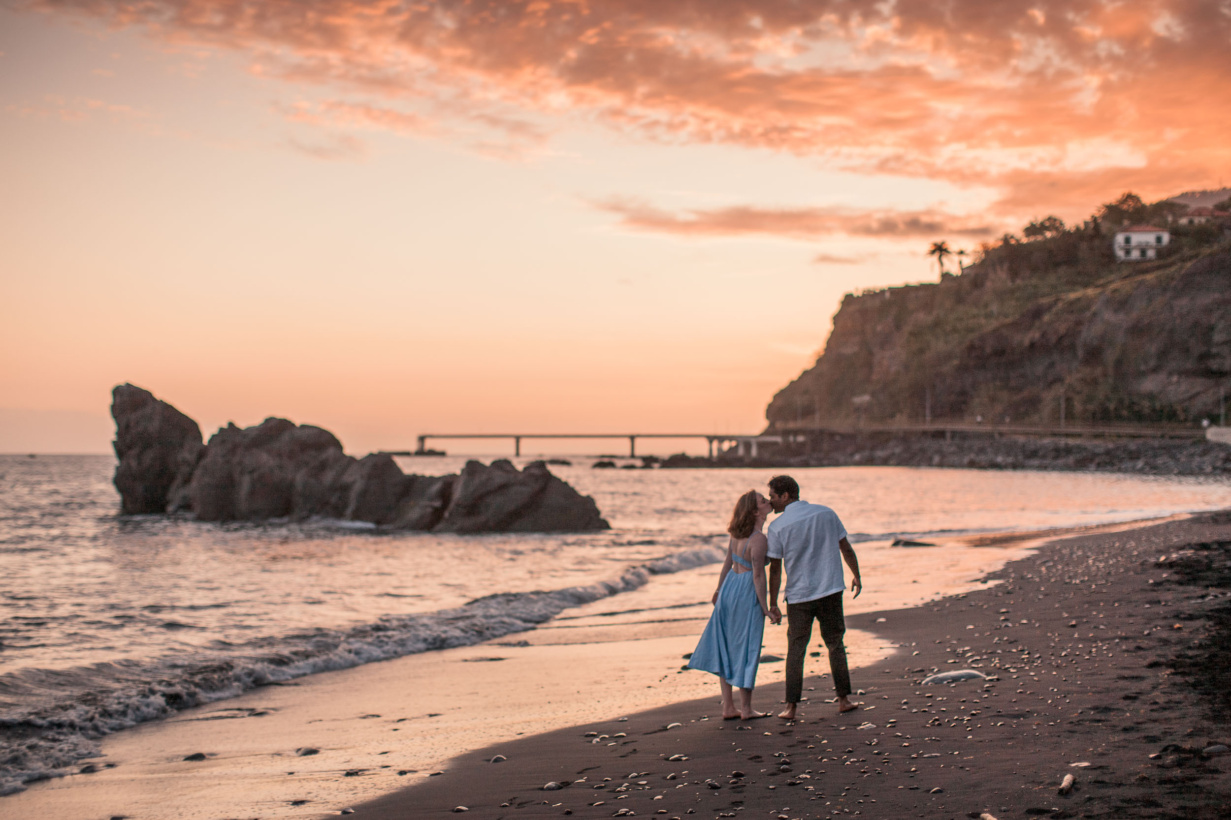 Couple walking at golden hour on Praia Formosa, Funchal, Madeira