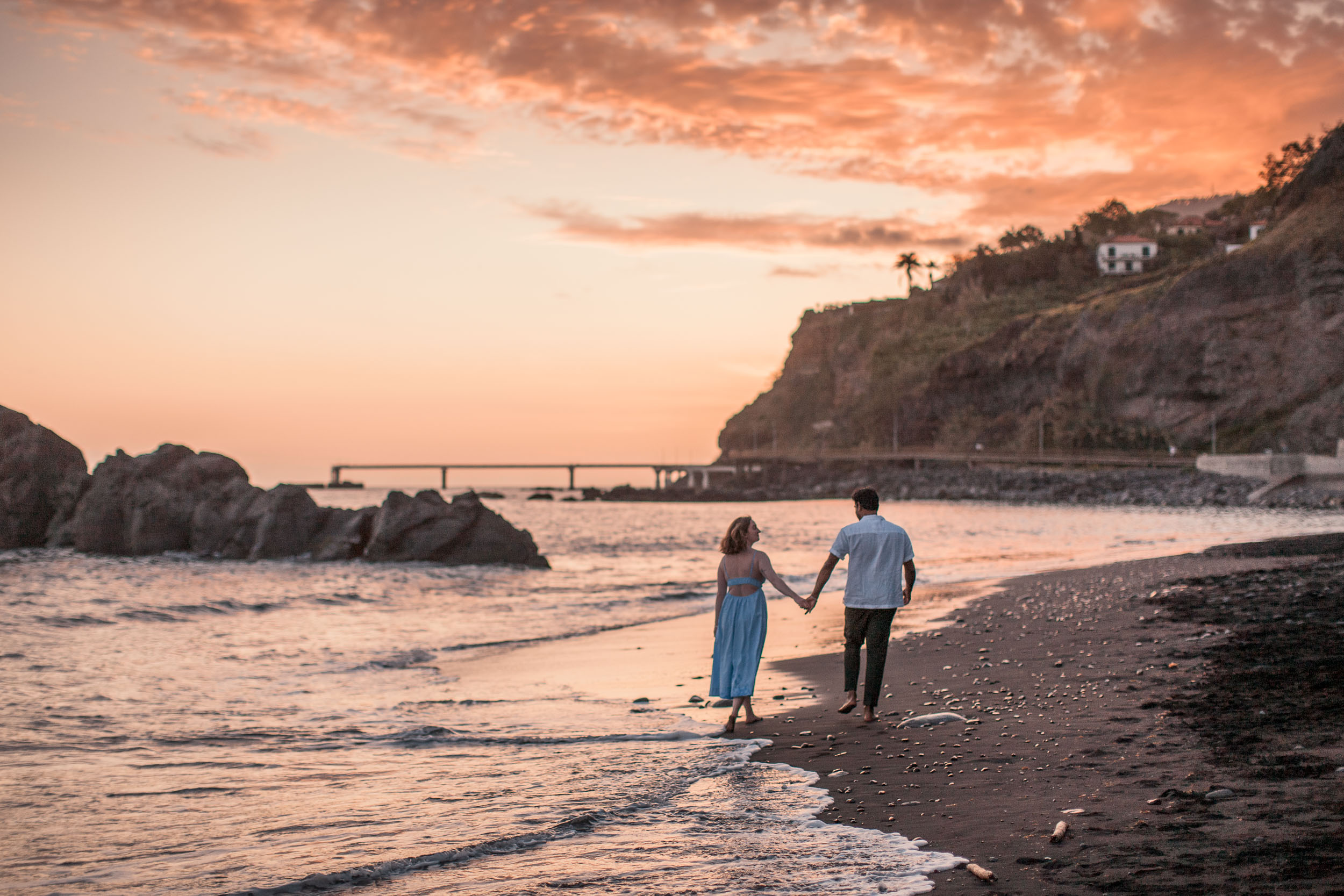 Engaged couple on rocky shore, Praia Formosa, Madeira