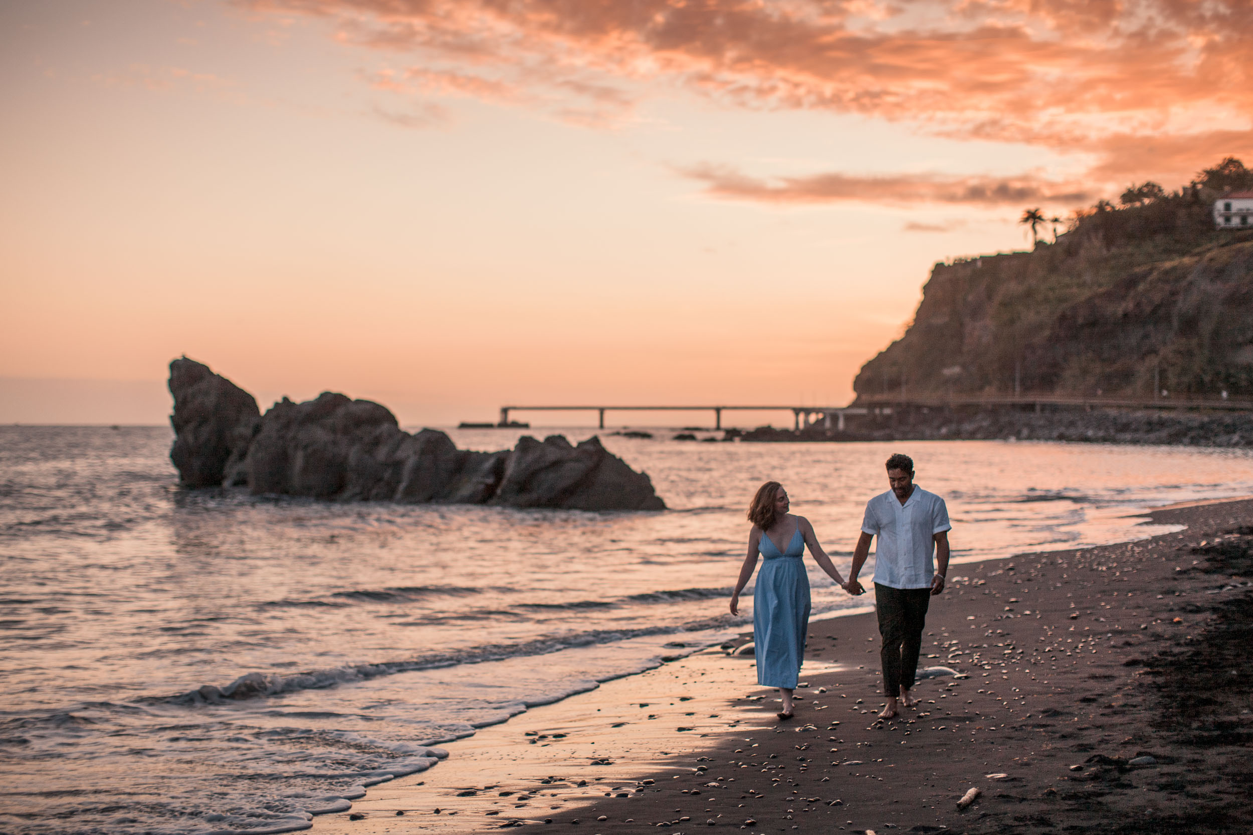 Couple holding hands at Atlantic shore, Praia Formosa, Madeira