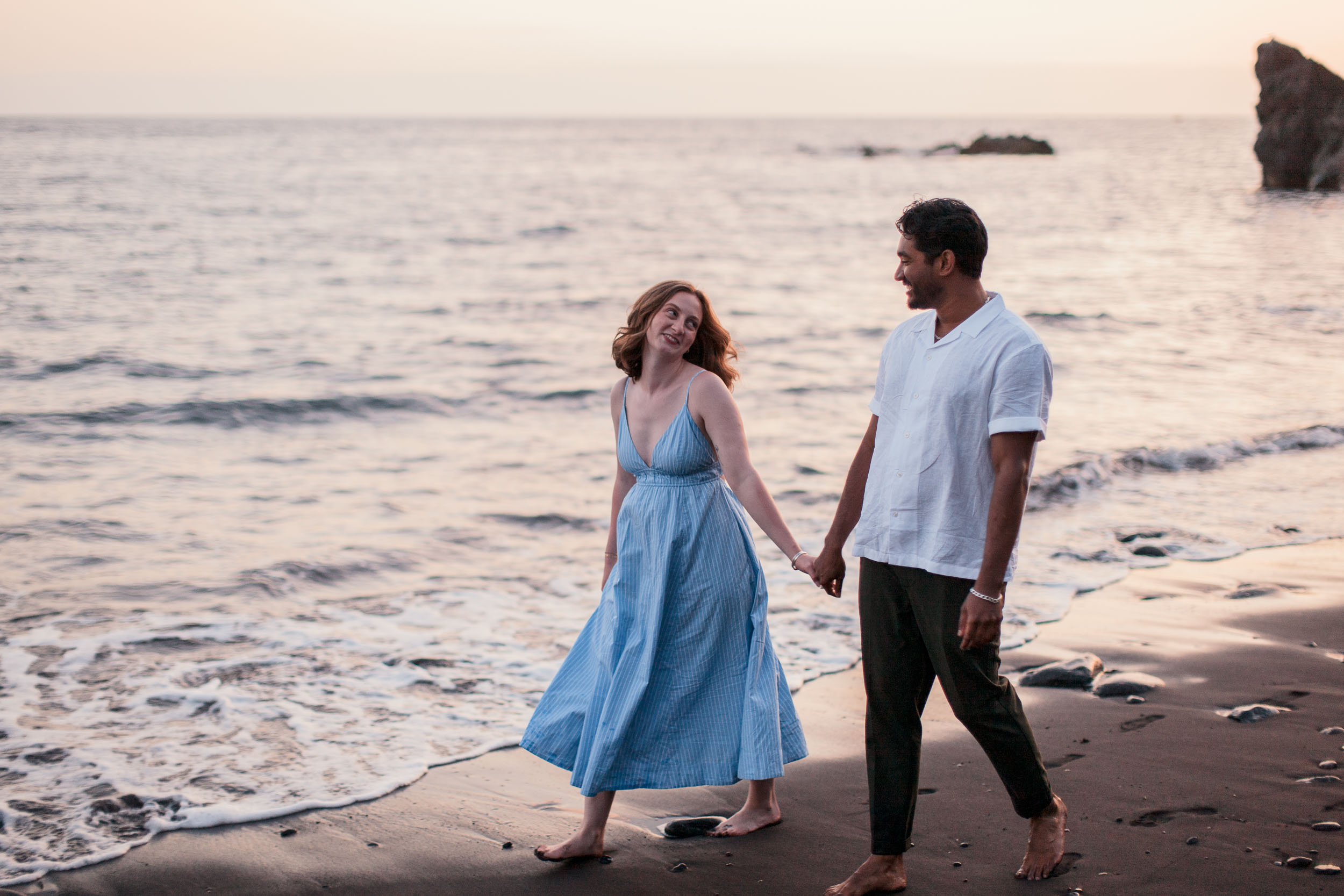 Couple on Praia Formosa beach at dusk, Funchal, Madeira