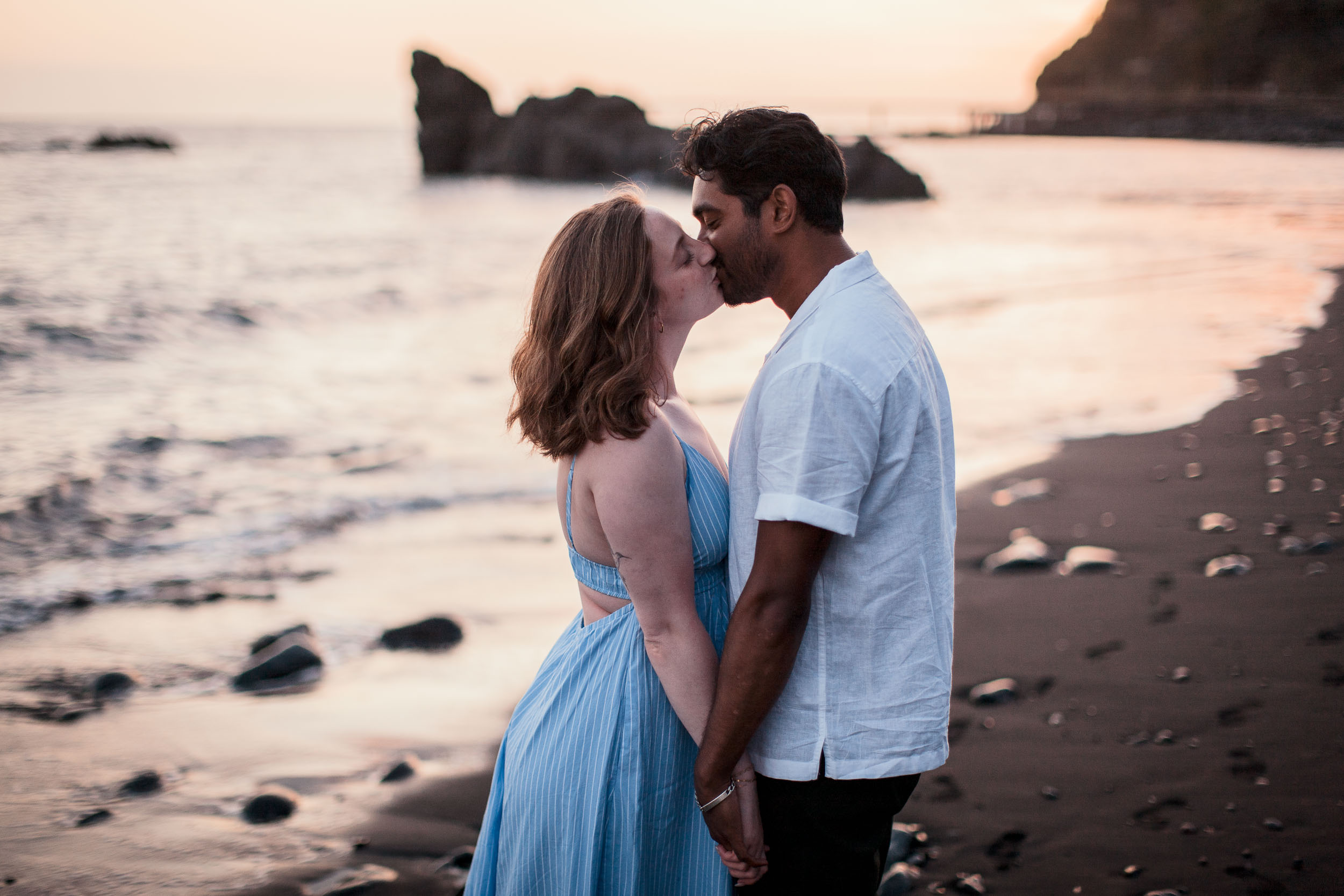 Couple kissing at Praia Formosa, Funchal, Madeira