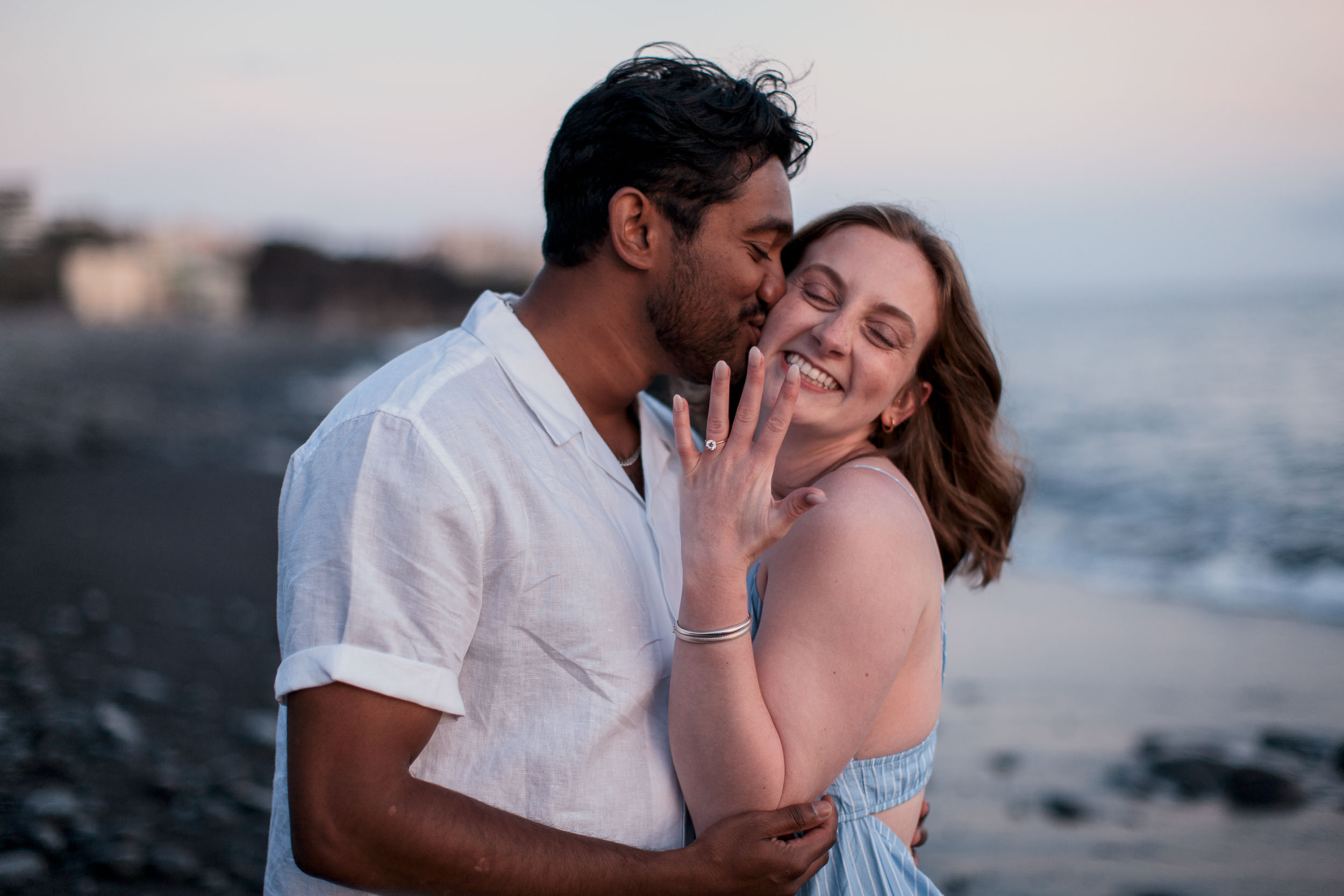 Woman with engagement ring at Praia Formosa beach, Madeira
