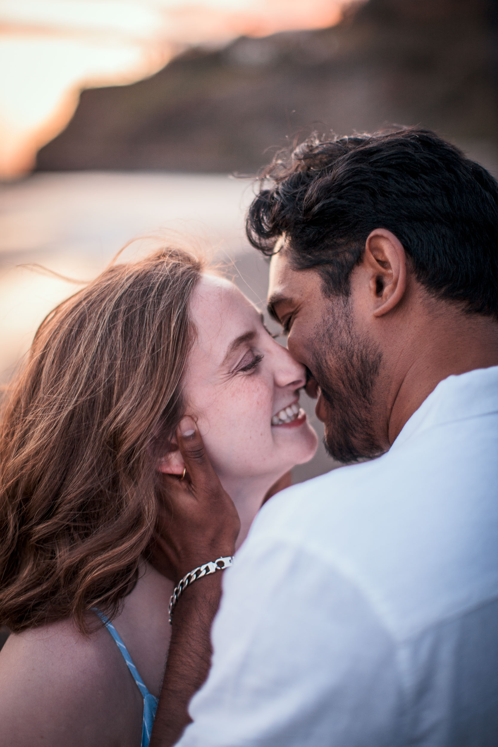 Couple kissing at Praia Formosa, Funchal, Madeira
