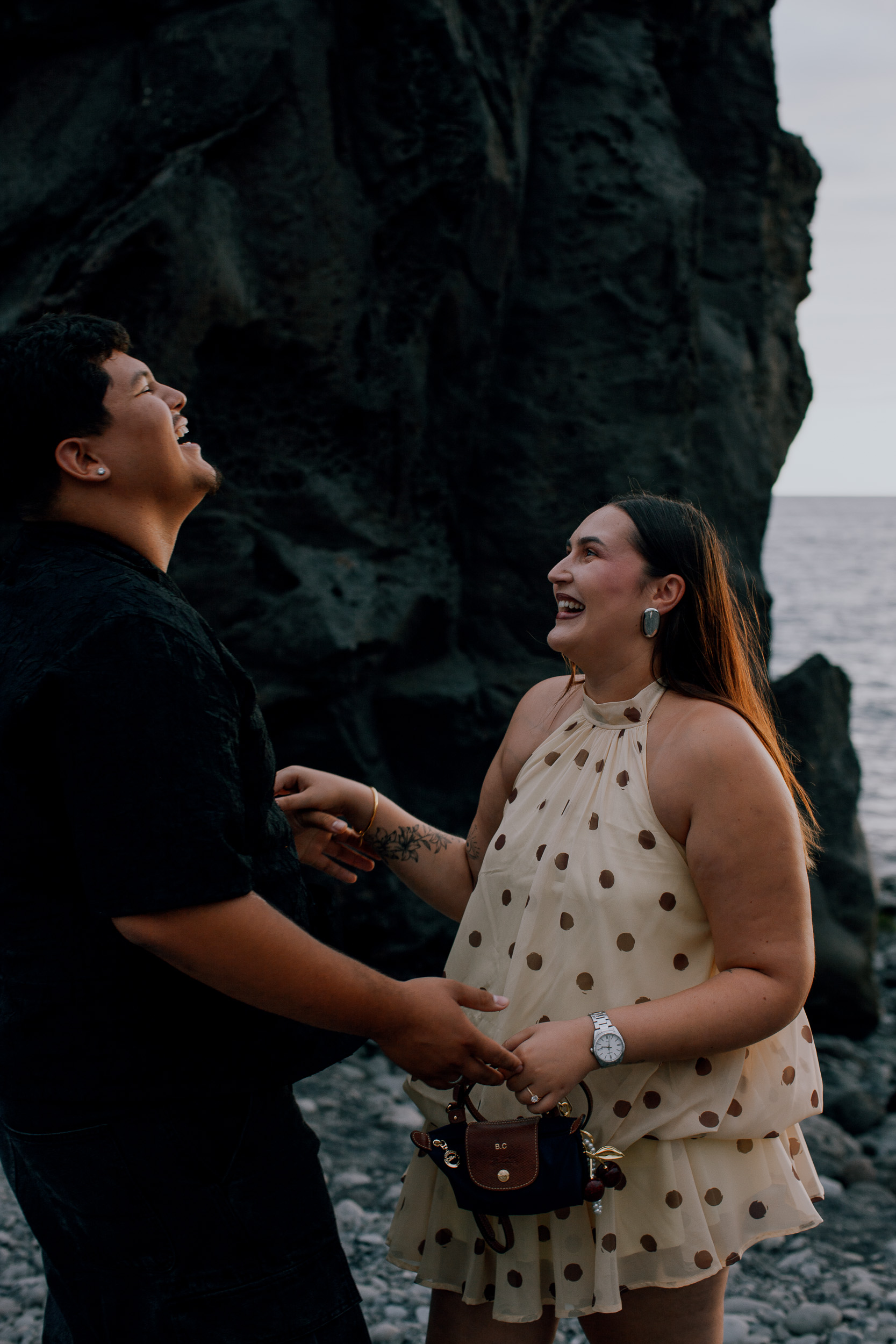 Laughing through happy tears right after the proposal, black cliff behind, Madeira