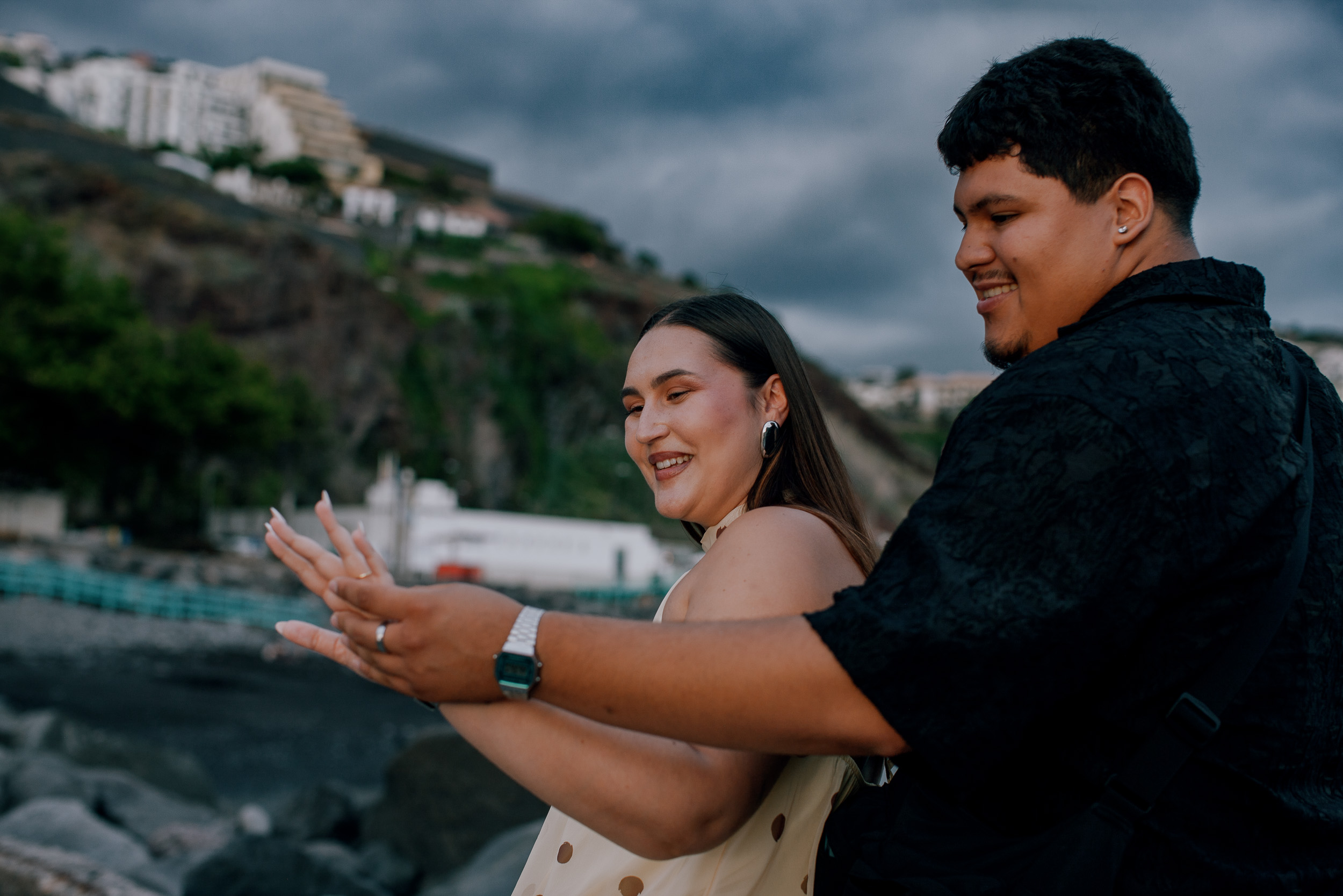 Admiring the new engagement ring together on the beach at dusk, Madeira