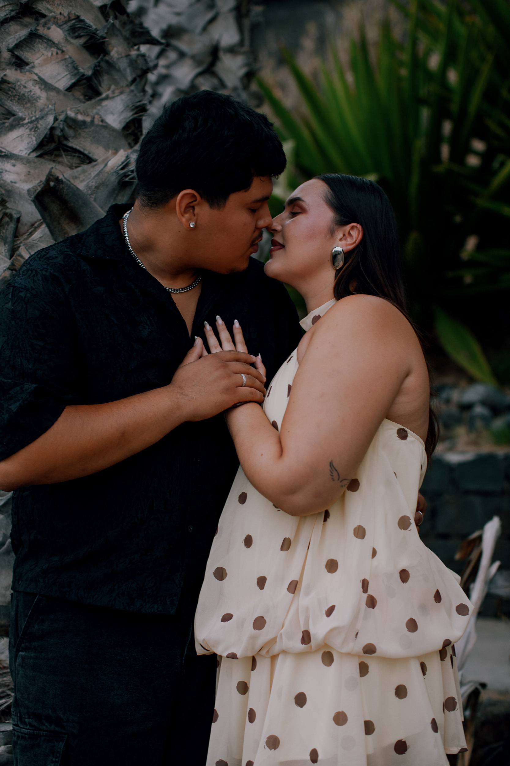 Forehead to forehead beside the palms in the last light, engagement on Madeira
