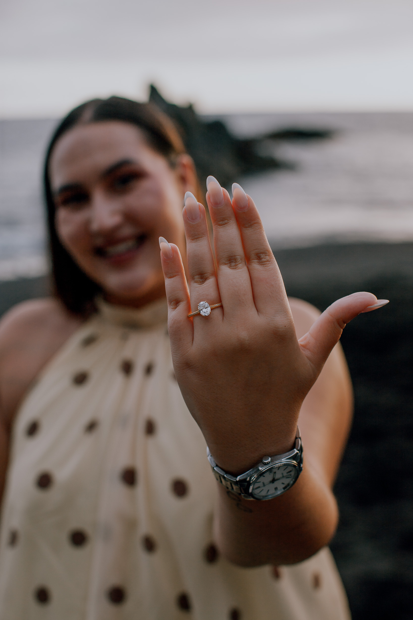 Showing off the engagement ring to the camera with a laugh, Praia Formosa, Madeira