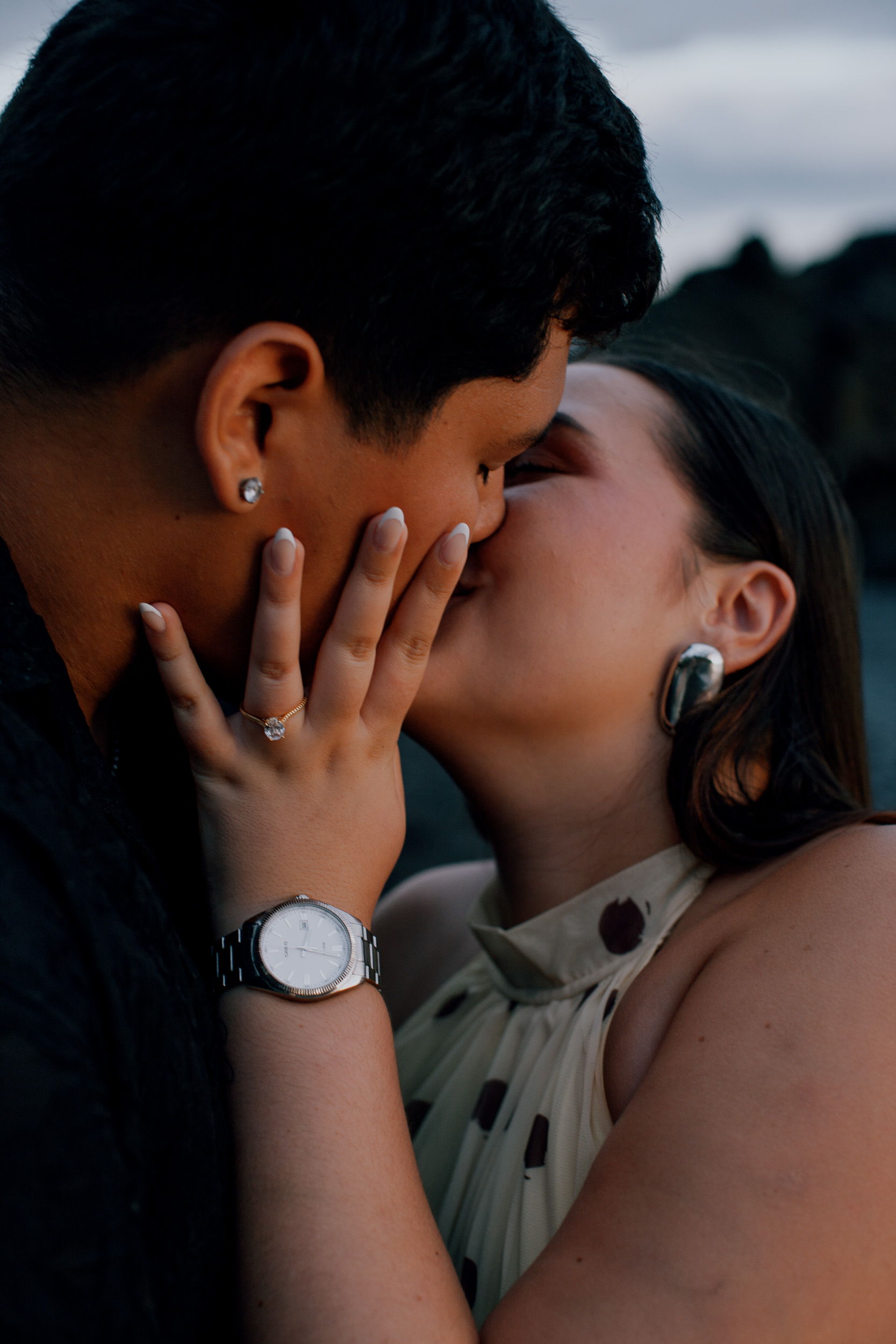 Her hand with the new ring against his cheek during a kiss, engagement on Madeira