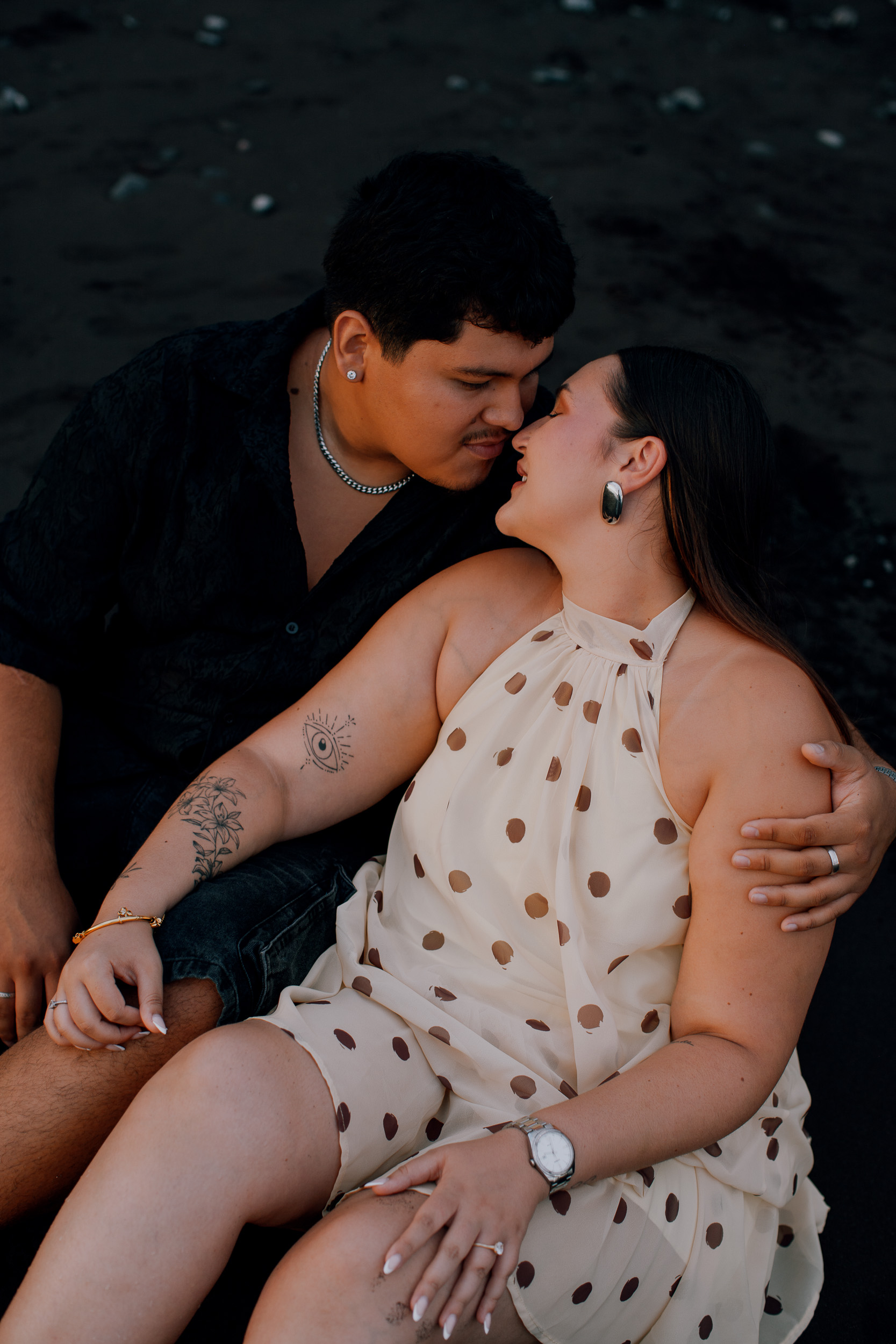 Almost kissing, seated on the dark beach after the proposal, Madeira
