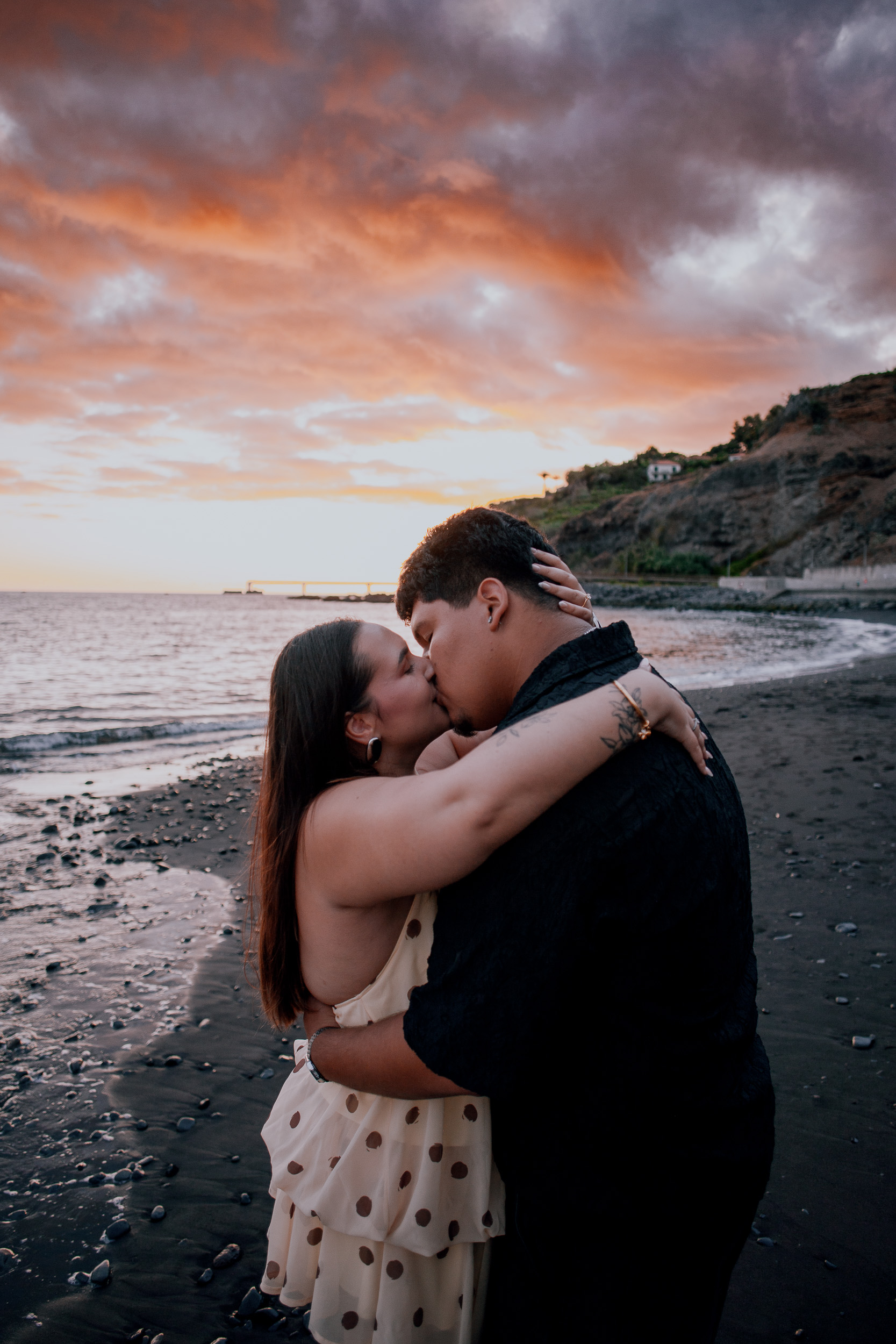 Deep embrace at the waterline as the sky turns pink and grey, Madeira