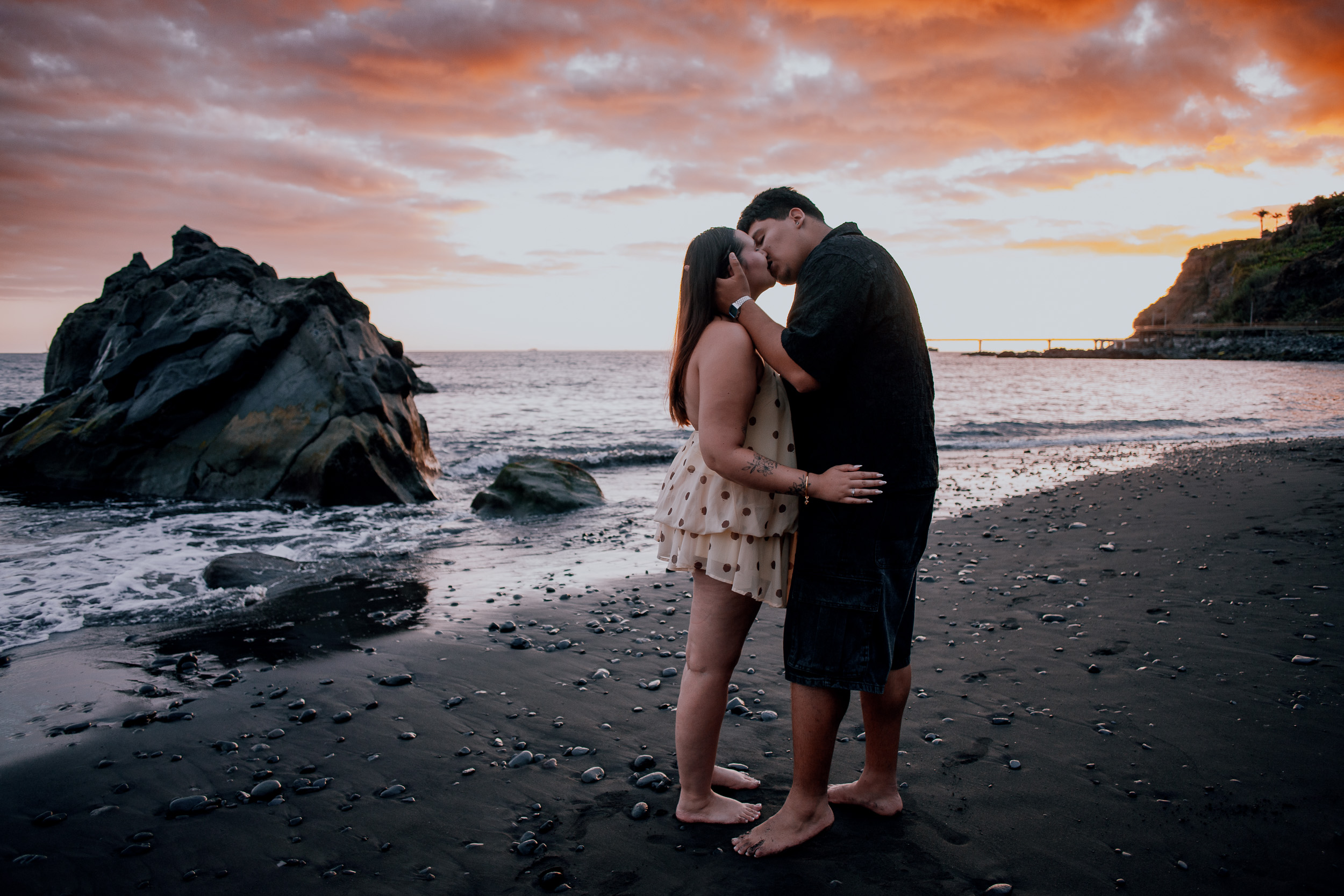 Holding hands in silhouette against the darkening ocean, Madeira