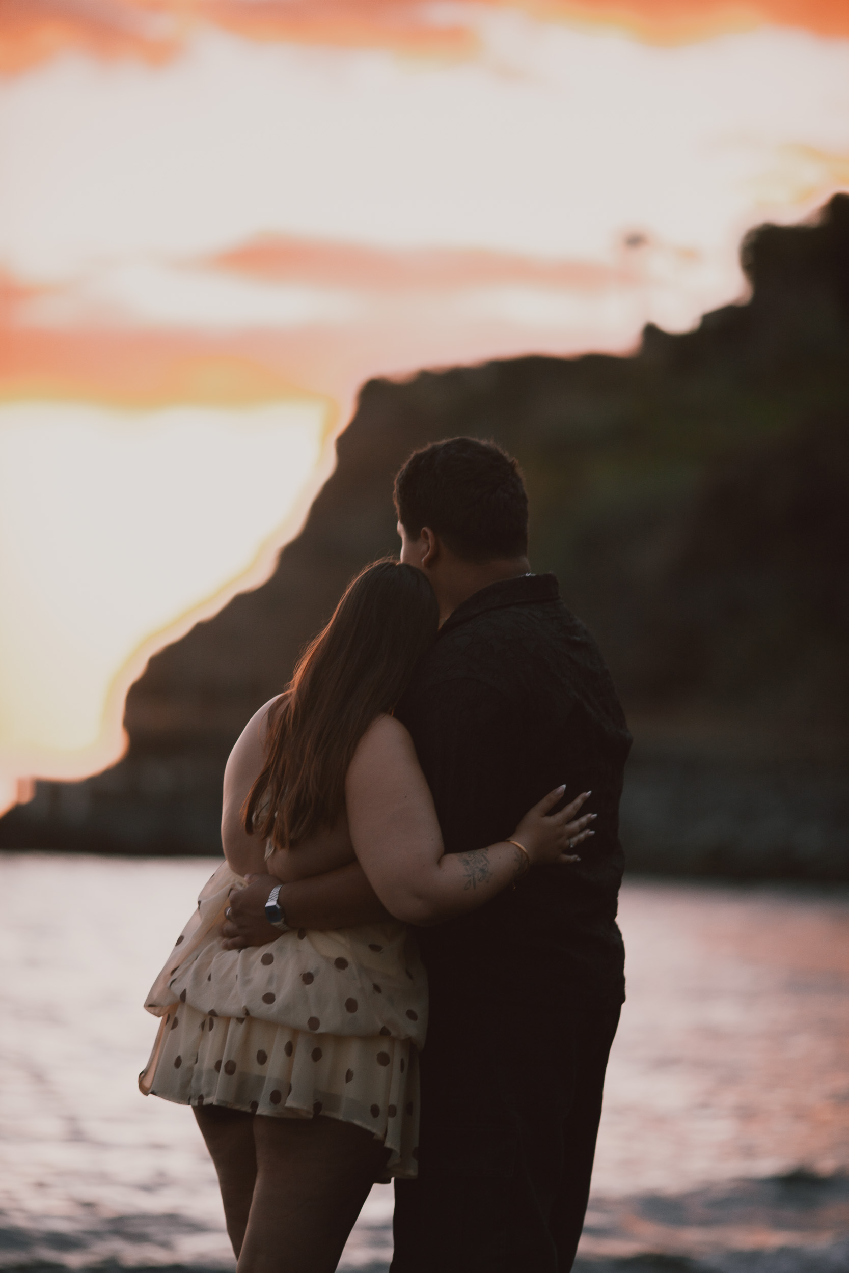 She smiles up at him in the soft dusk light, engaged couple on Madeira