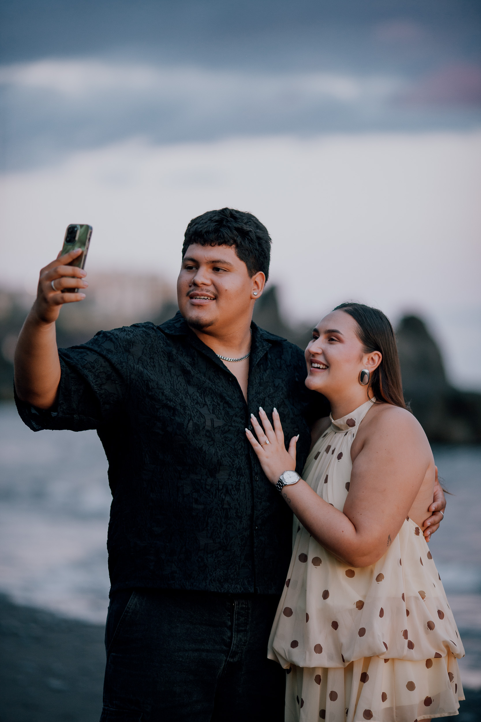 Showing the ring to family on a video call from the dark sand, Madeira