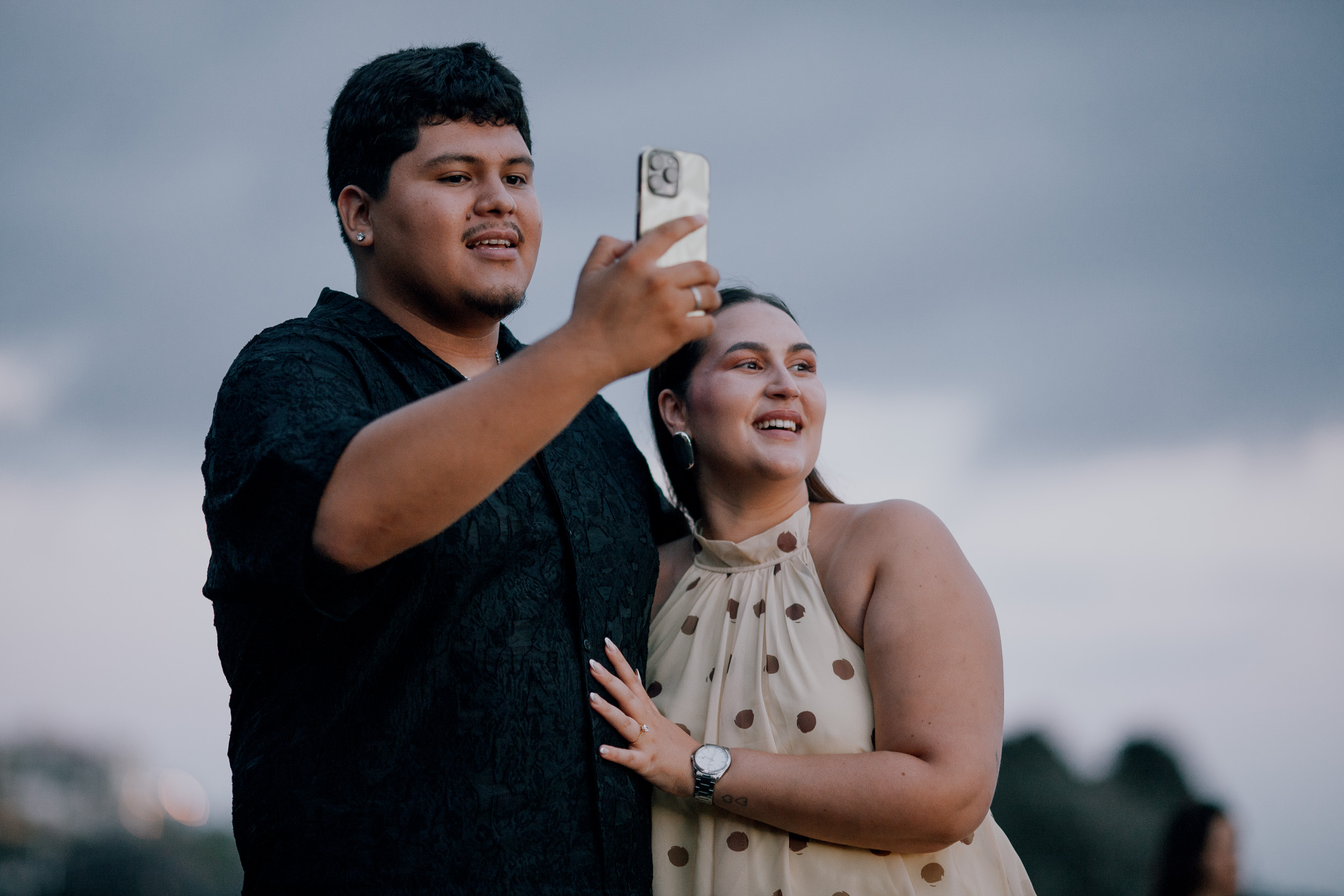 Taking an engagement selfie against the rocks and grey sky, Madeira