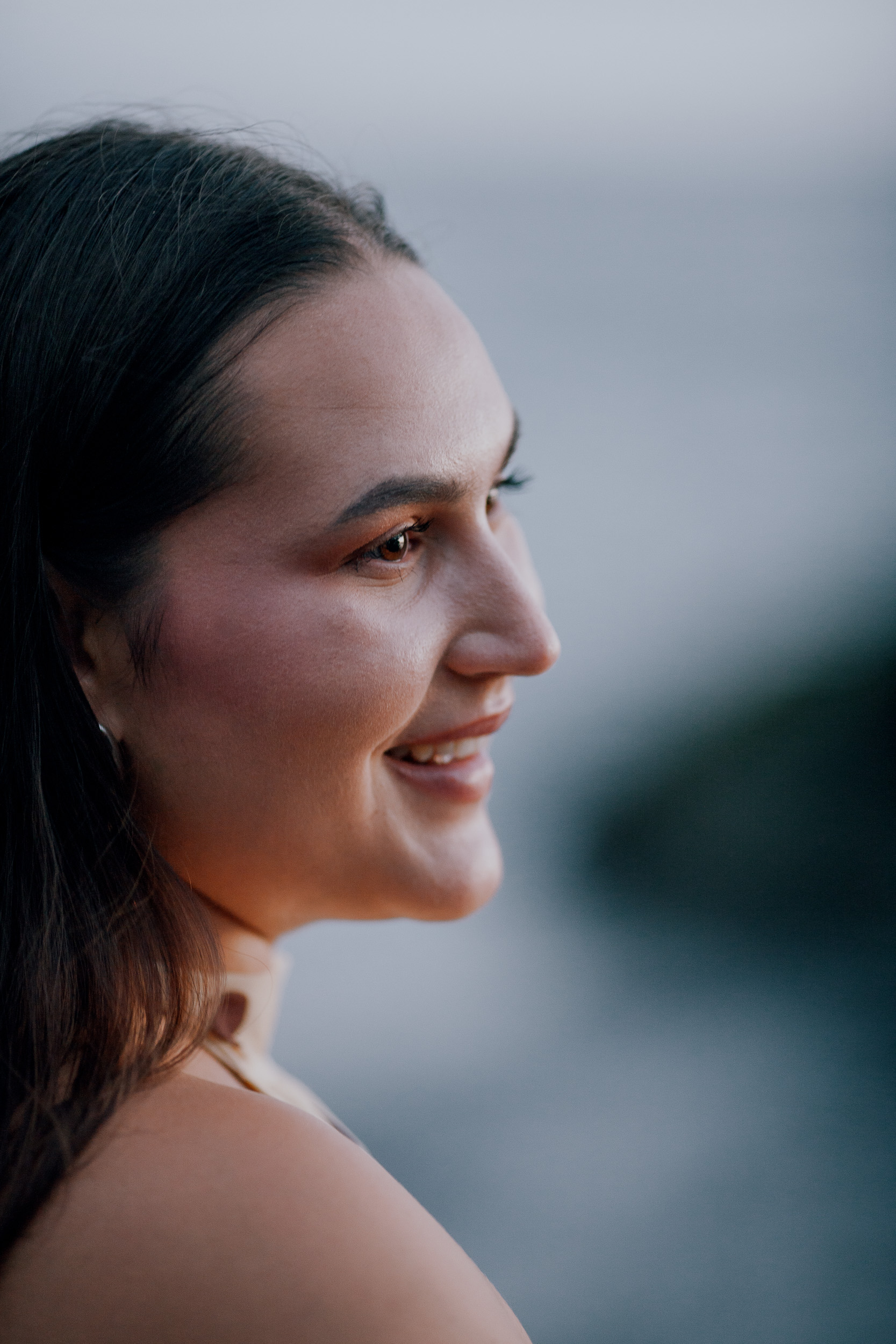 Profile portrait against the pale evening sea, engagement session on Madeira