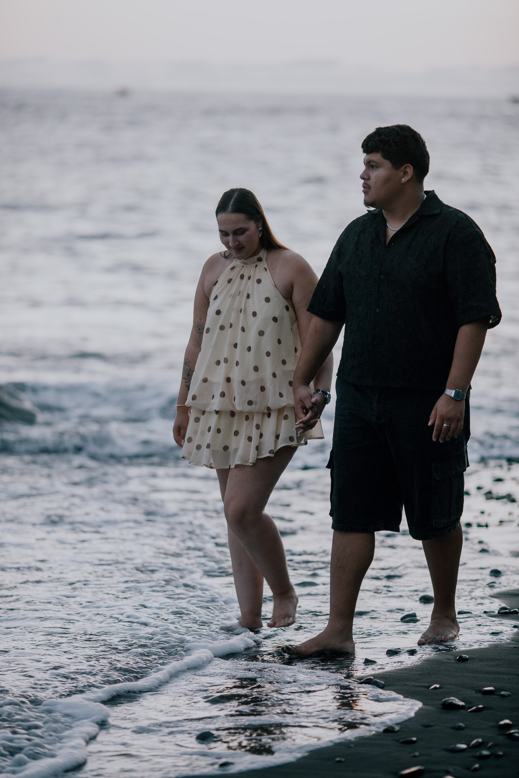 Standing in the surf together at blue hour, Praia Formosa, Madeira