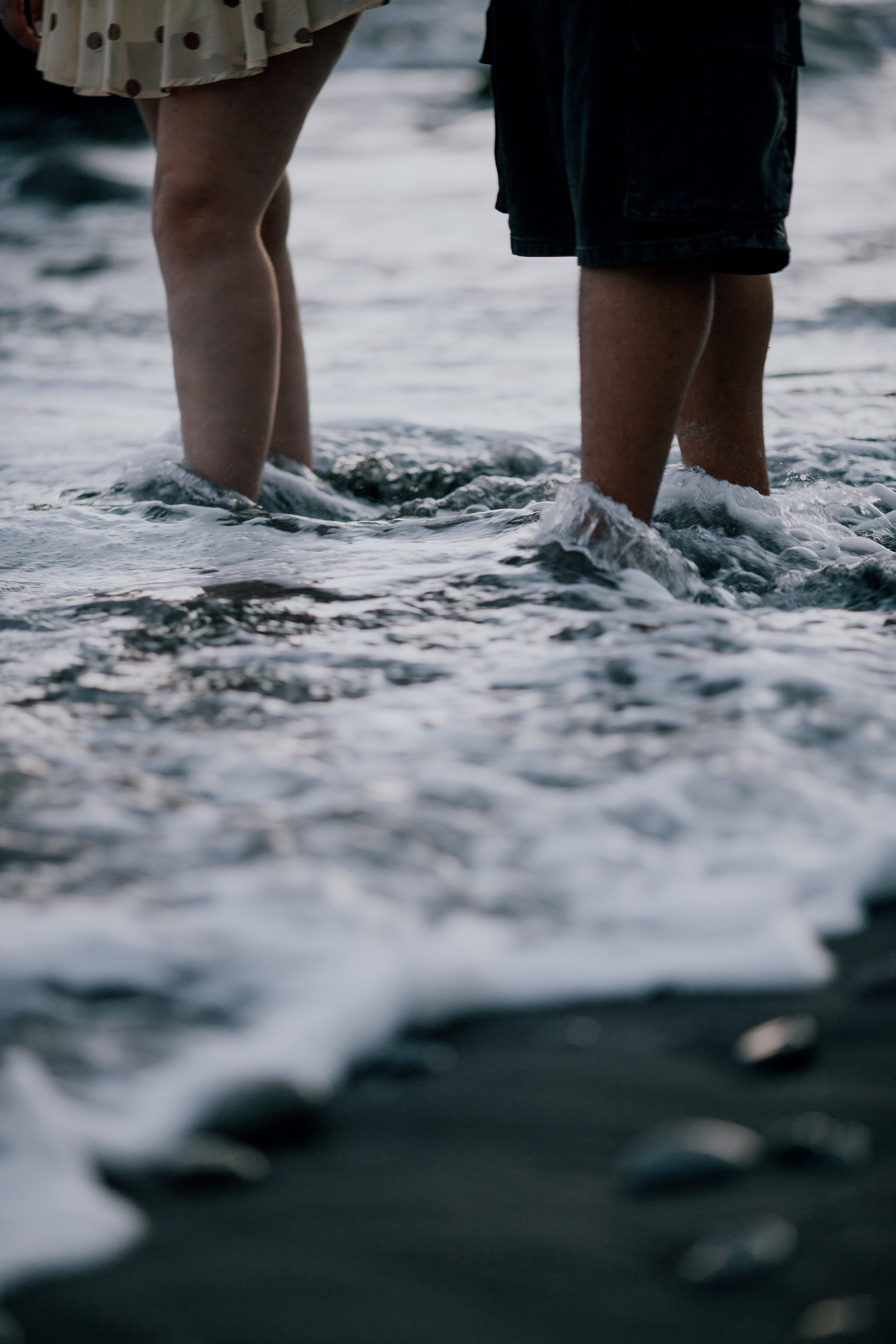 Feet in the foam on the dark pebbles at the end of the session, Madeira