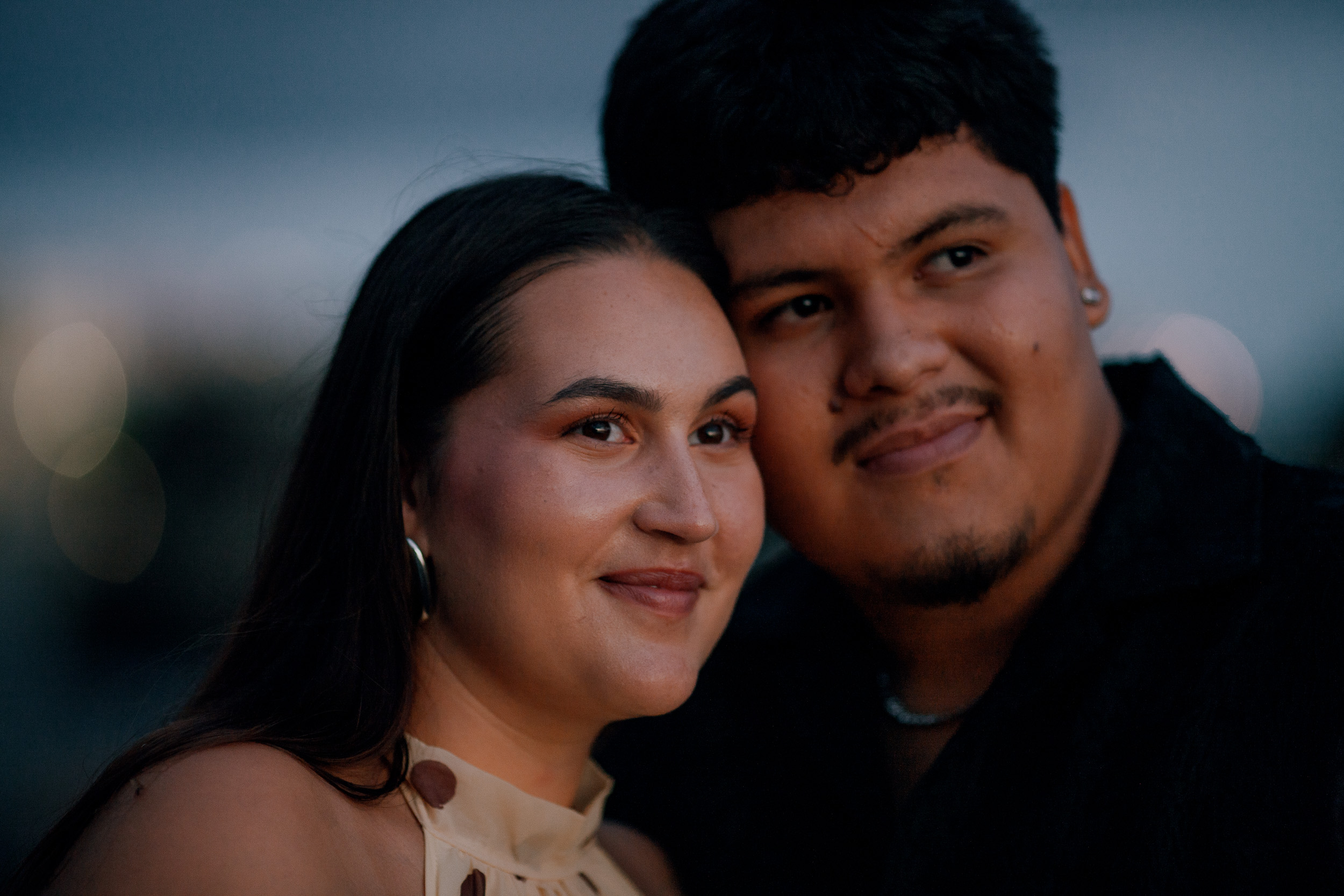 Cheek to cheek portrait at blue hour on the beach, newly engaged on Madeira