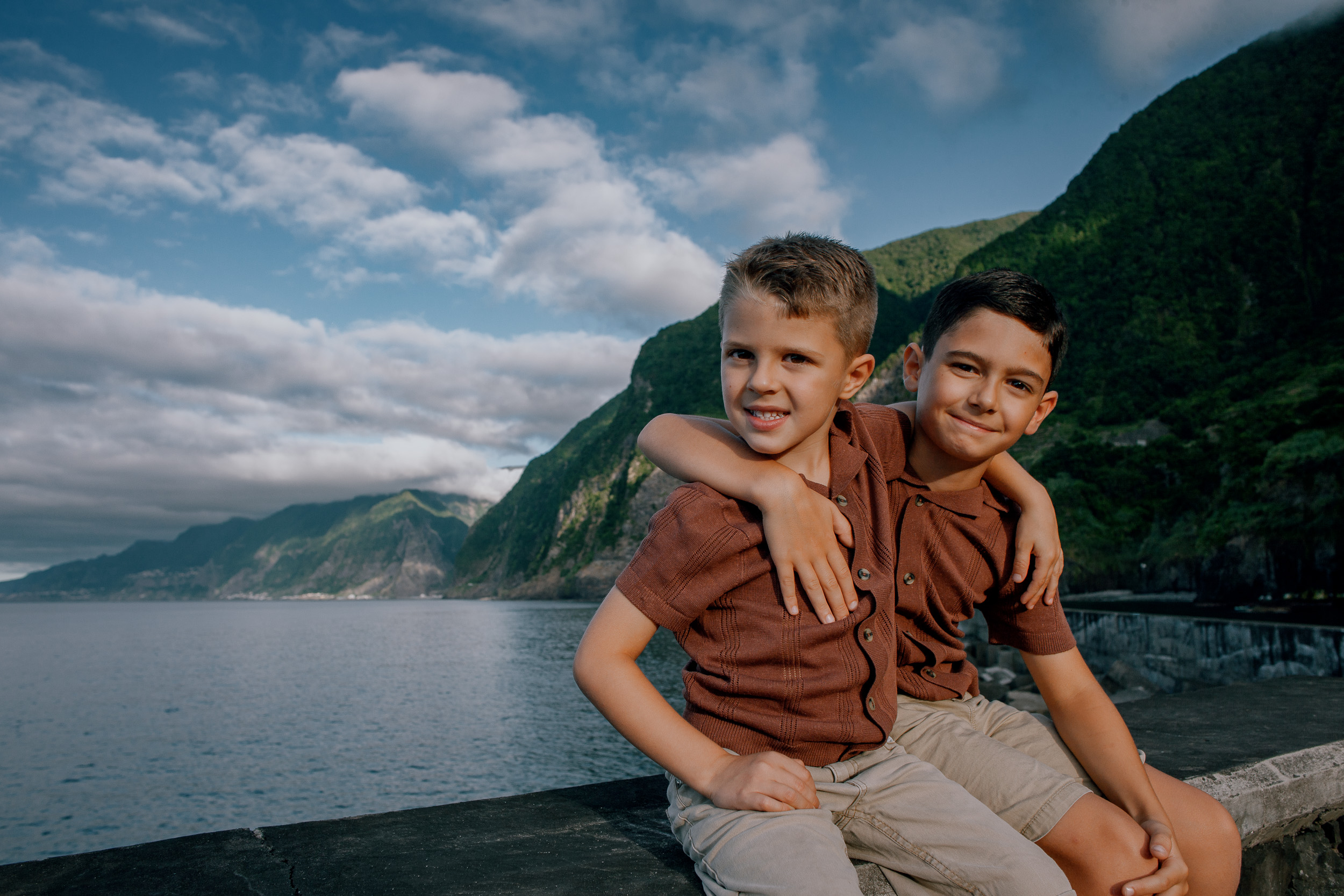 The older boy hugging his little brother on the wall, Seixal, Madeira