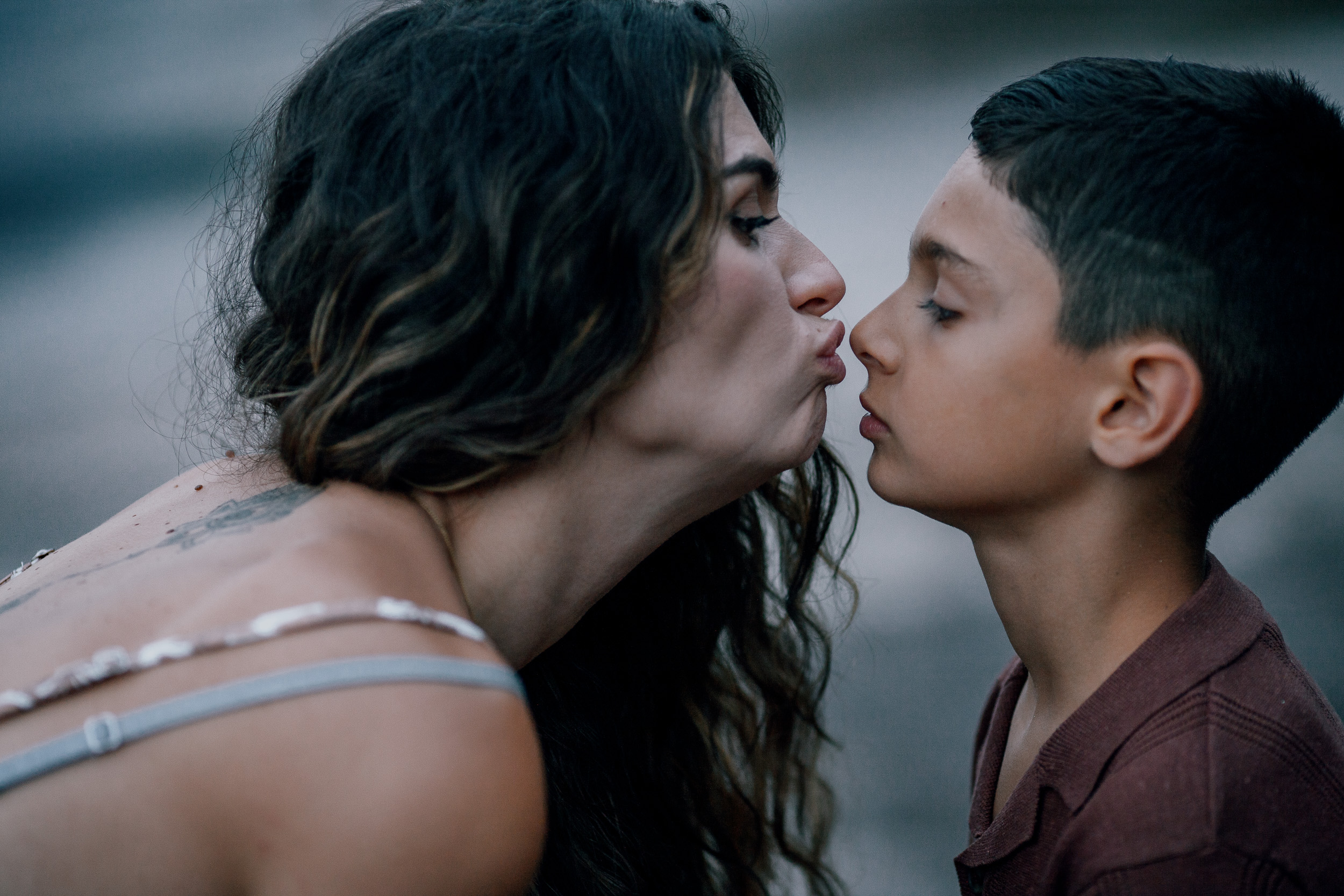 Mum leaning in to kiss the older son, Seixal Beach, Madeira