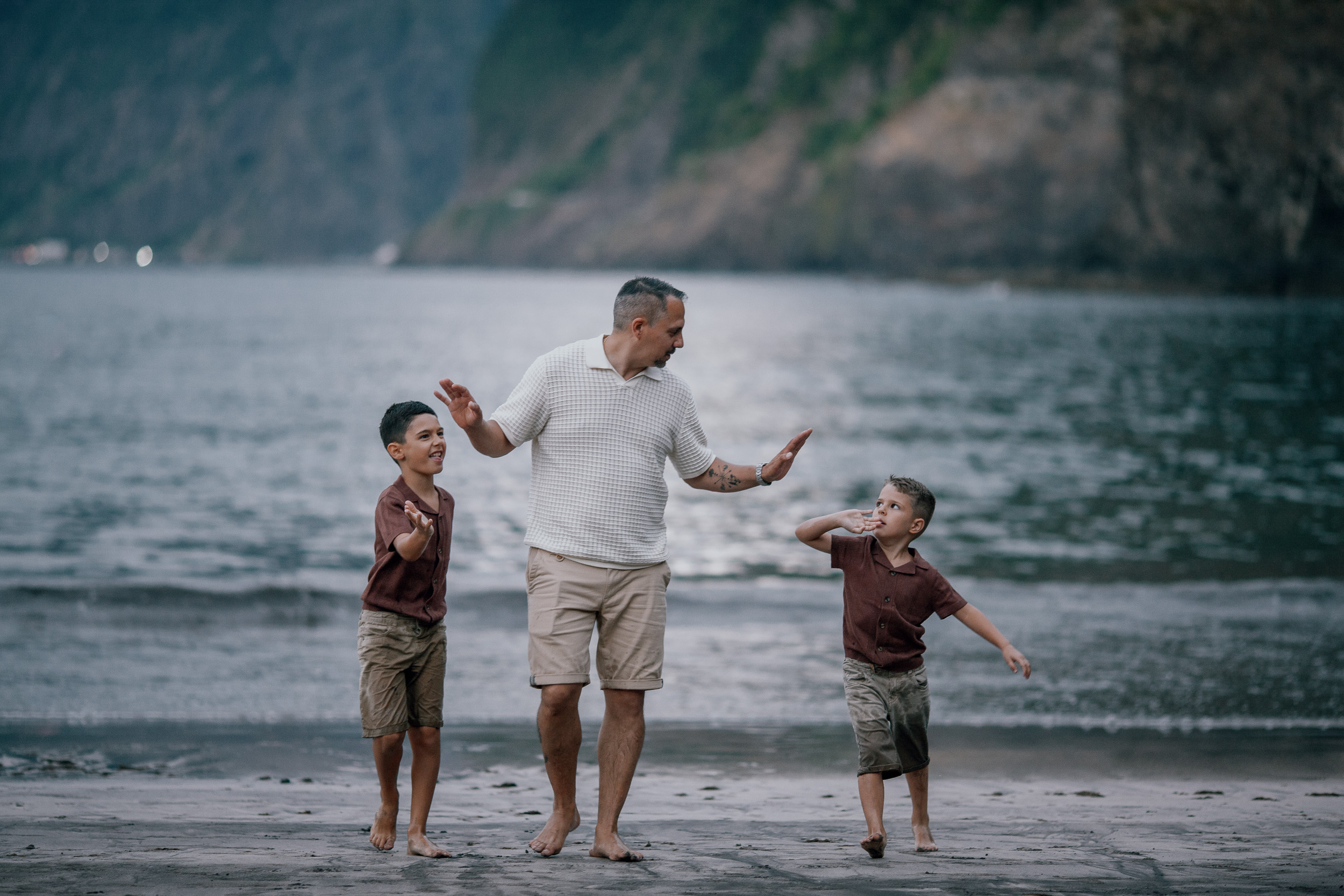 Dad dancing with both boys in the shallows, Seixal Beach, Madeira