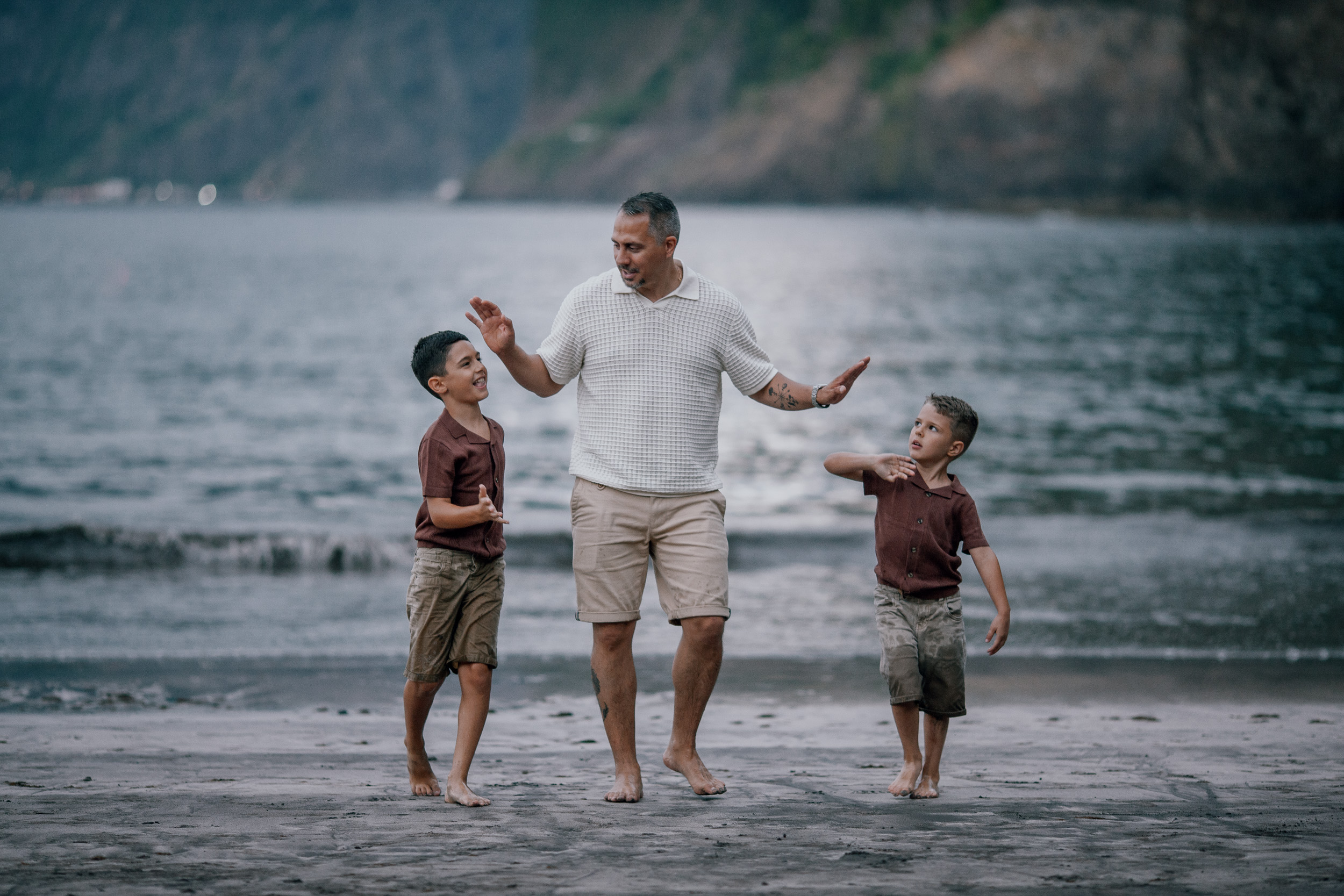 Father walking the beach with the boys at nightfall, Seixal, Madeira
