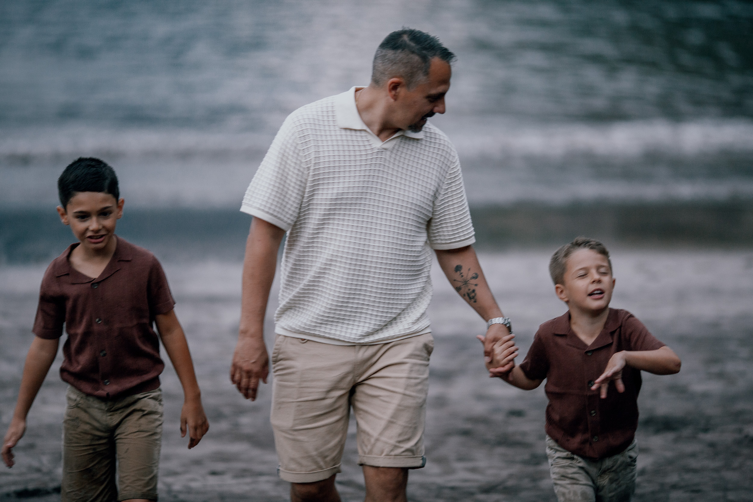 Dad and the boys walking hand in hand at last light, Seixal Beach, Madeira
