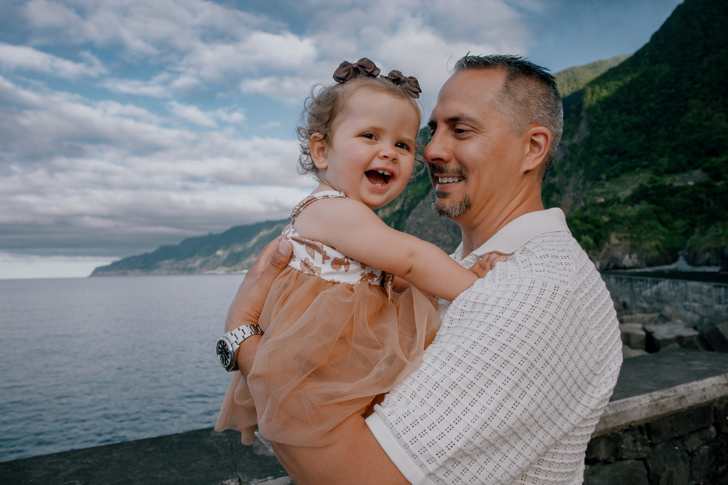 Daughter giggling nose to nose with her dad, Seixal Beach, Madeira