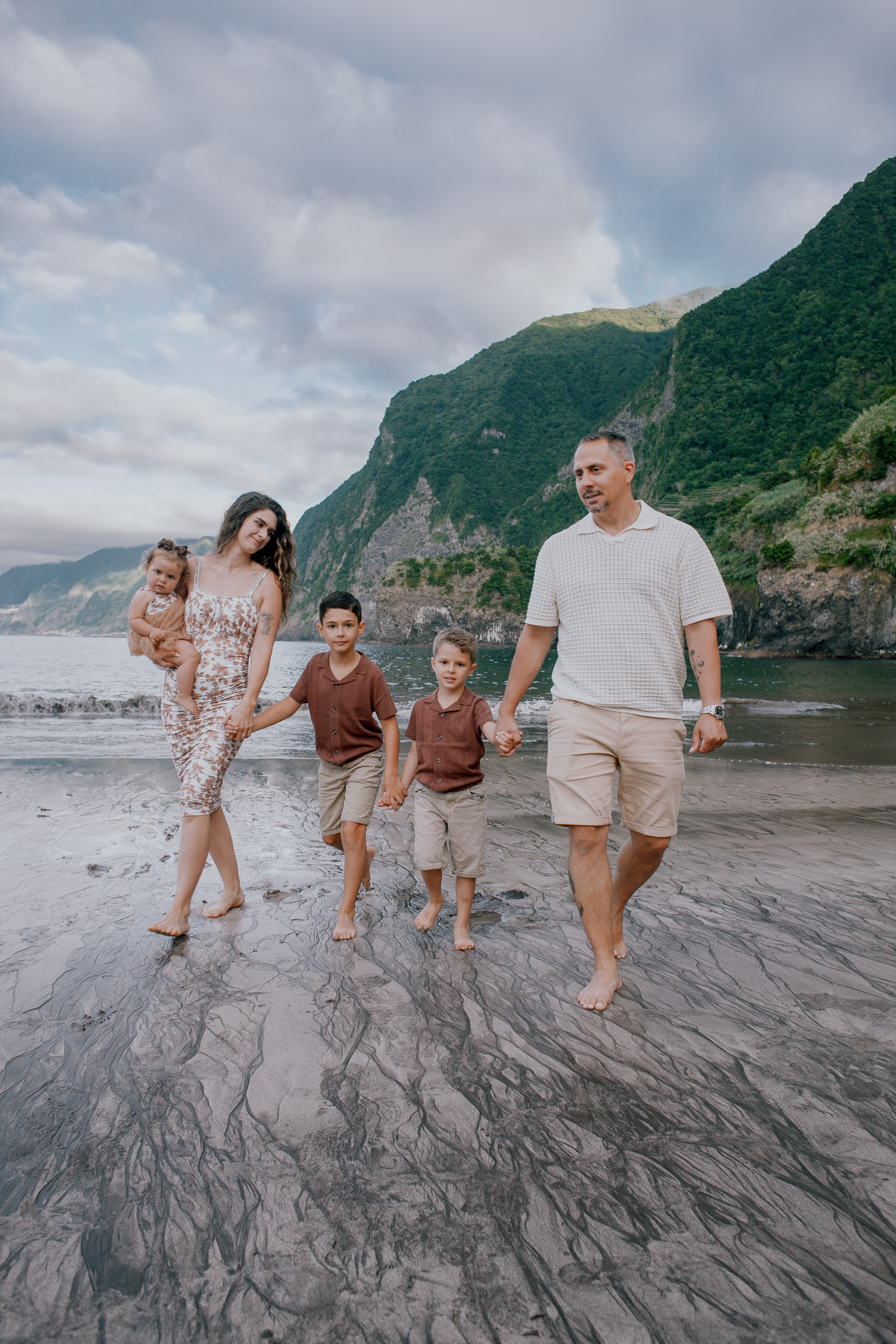 Parents and kids walking the beach hand in hand, Seixal, Madeira