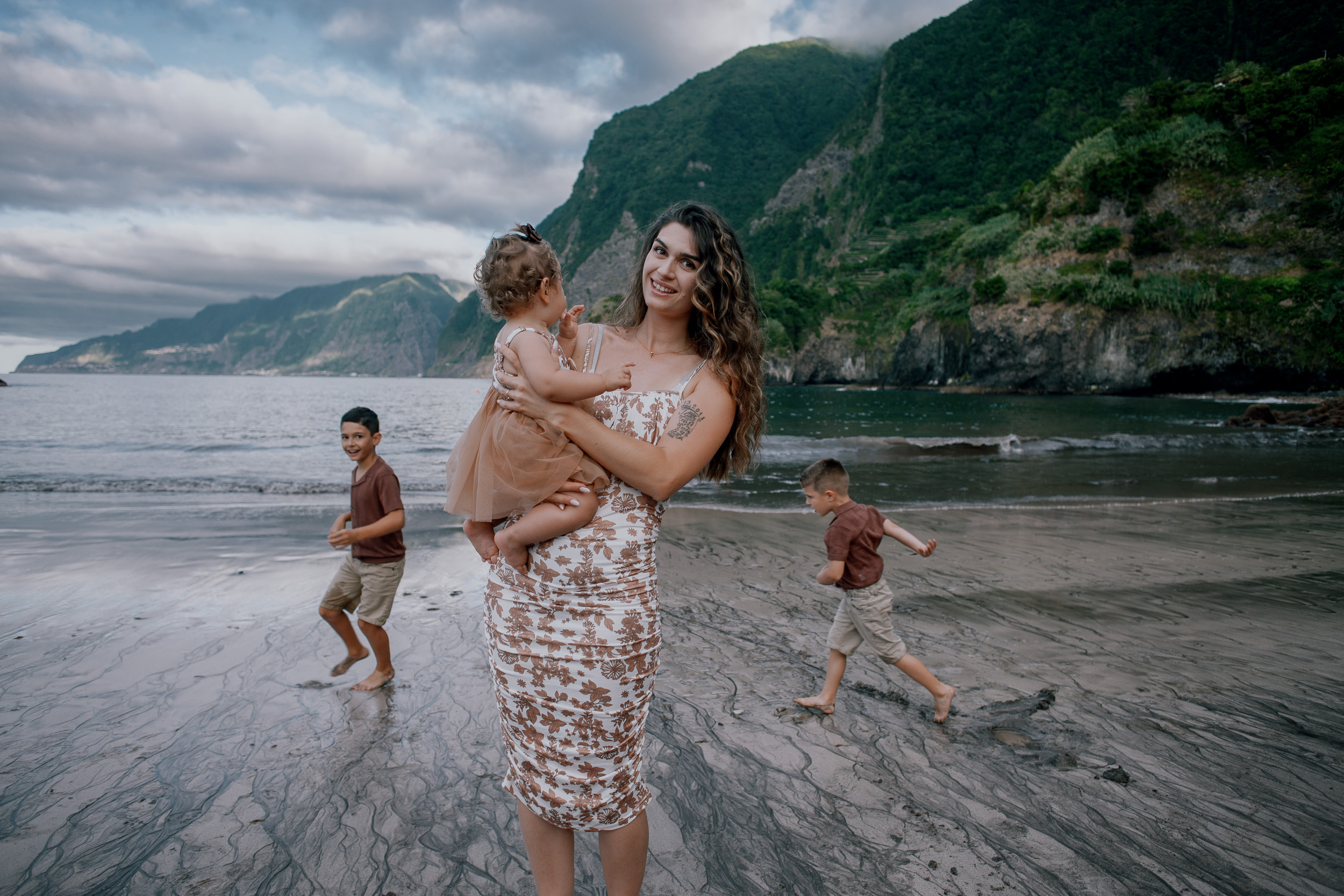 Mum with the baby watching the boys run the beach, Seixal, Madeira