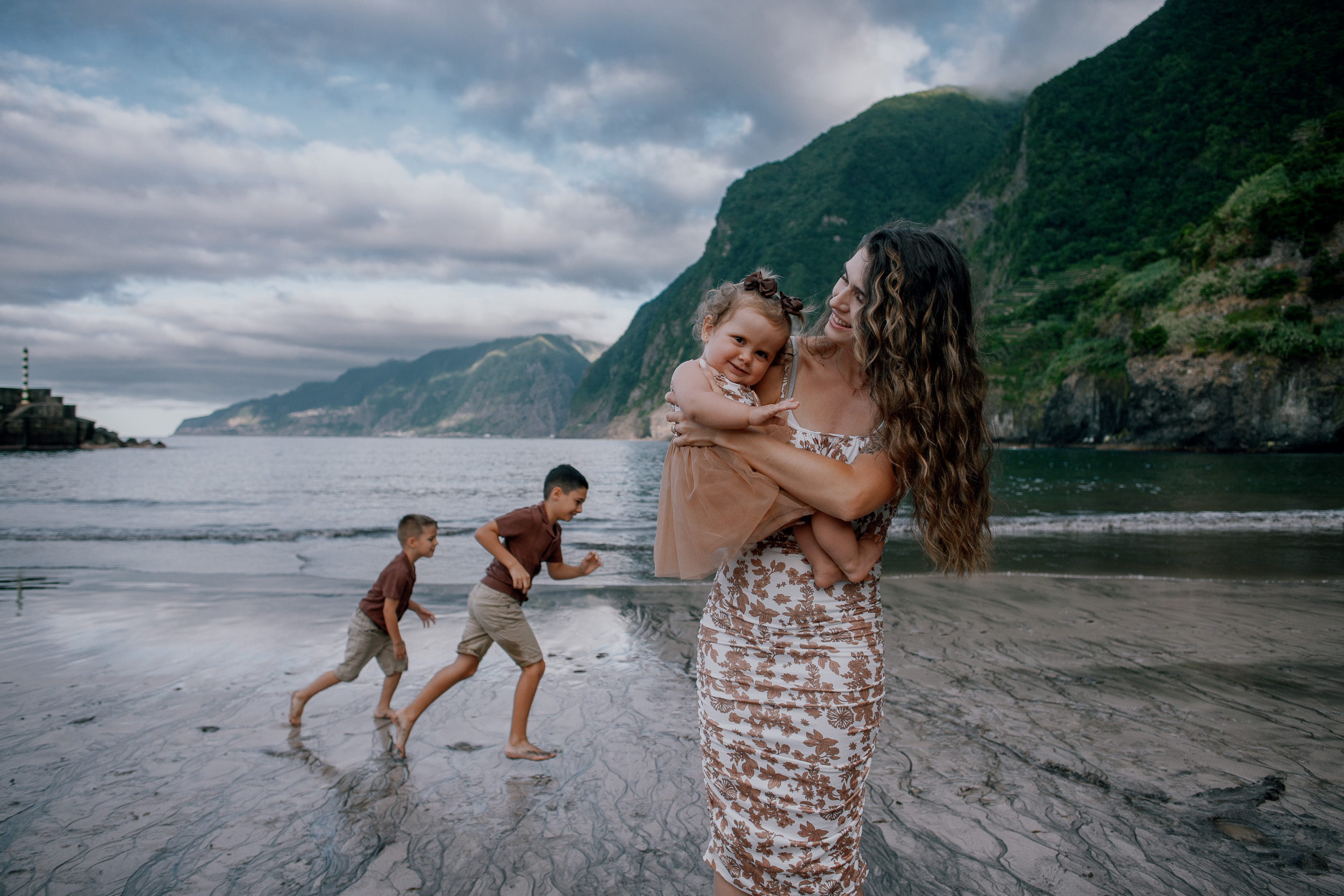 Mum and the baby girl cheek to cheek at the beach, Seixal, Madeira