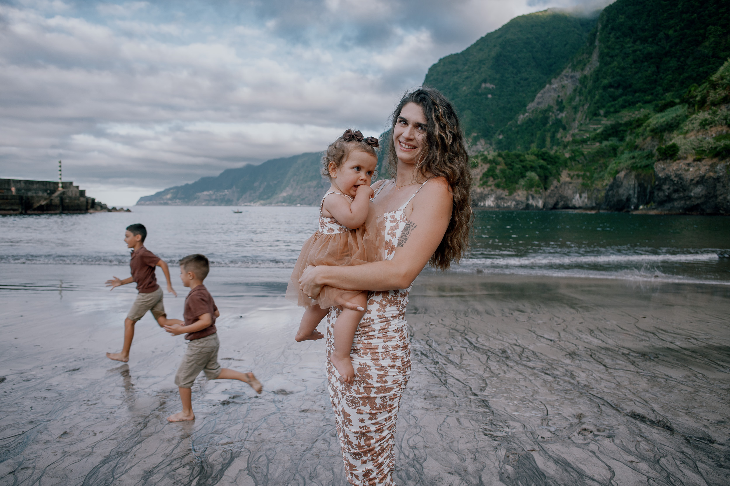 Parents together as the boys run the shallows, Seixal, Madeira